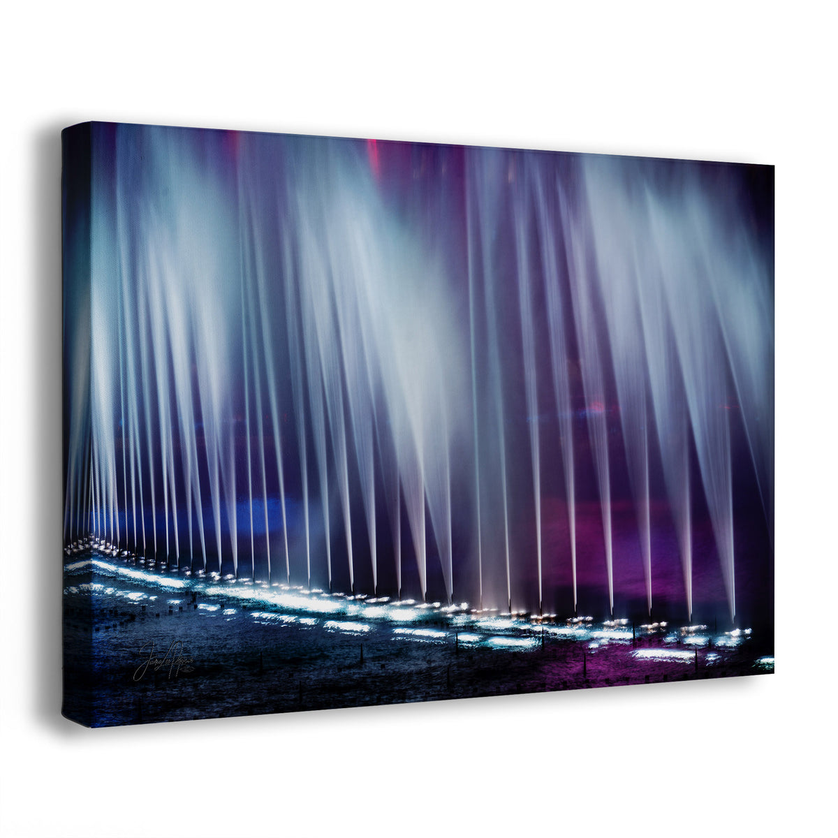 An abstract fountain wall art canvas showing a nighttime scene from the Bellagio fountains in Las Vegas, Nevada, with vertical light jets in blue, purple, and white over a dark ground, photographed against a clean white background.