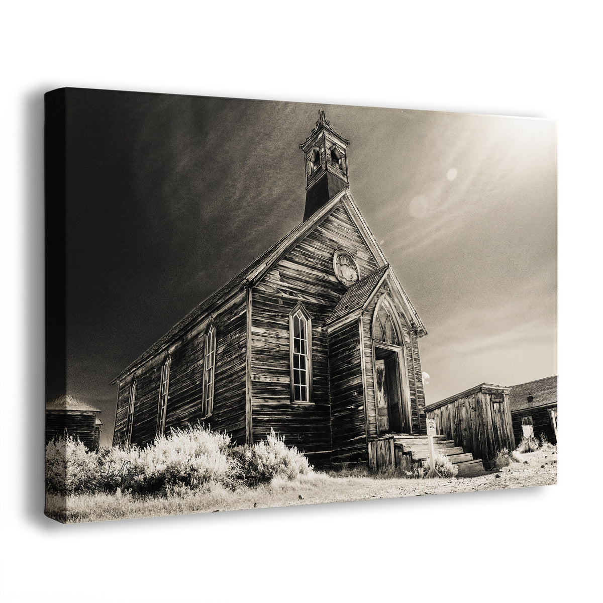 A rectangular wall art canvas showing a sepia-toned photograph of an old wooden church building with a steeple from Bodie Ghost Town in California, photographed against a plain white background.