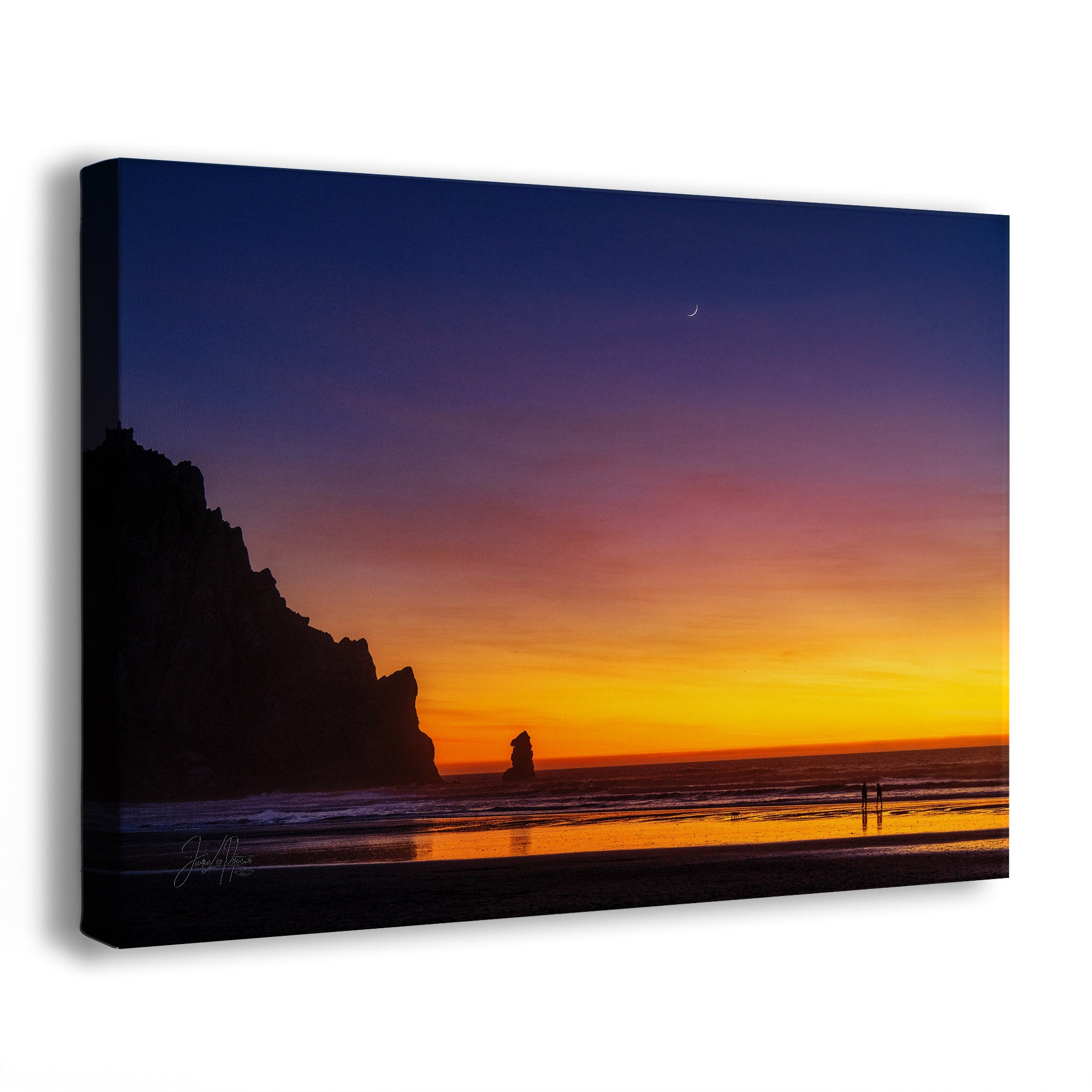 A side view of a canvas wall art print of a glowing sunset in Morro Bay, California, with a crescent moon in the sky and two small figures on the shore watching the sunset.