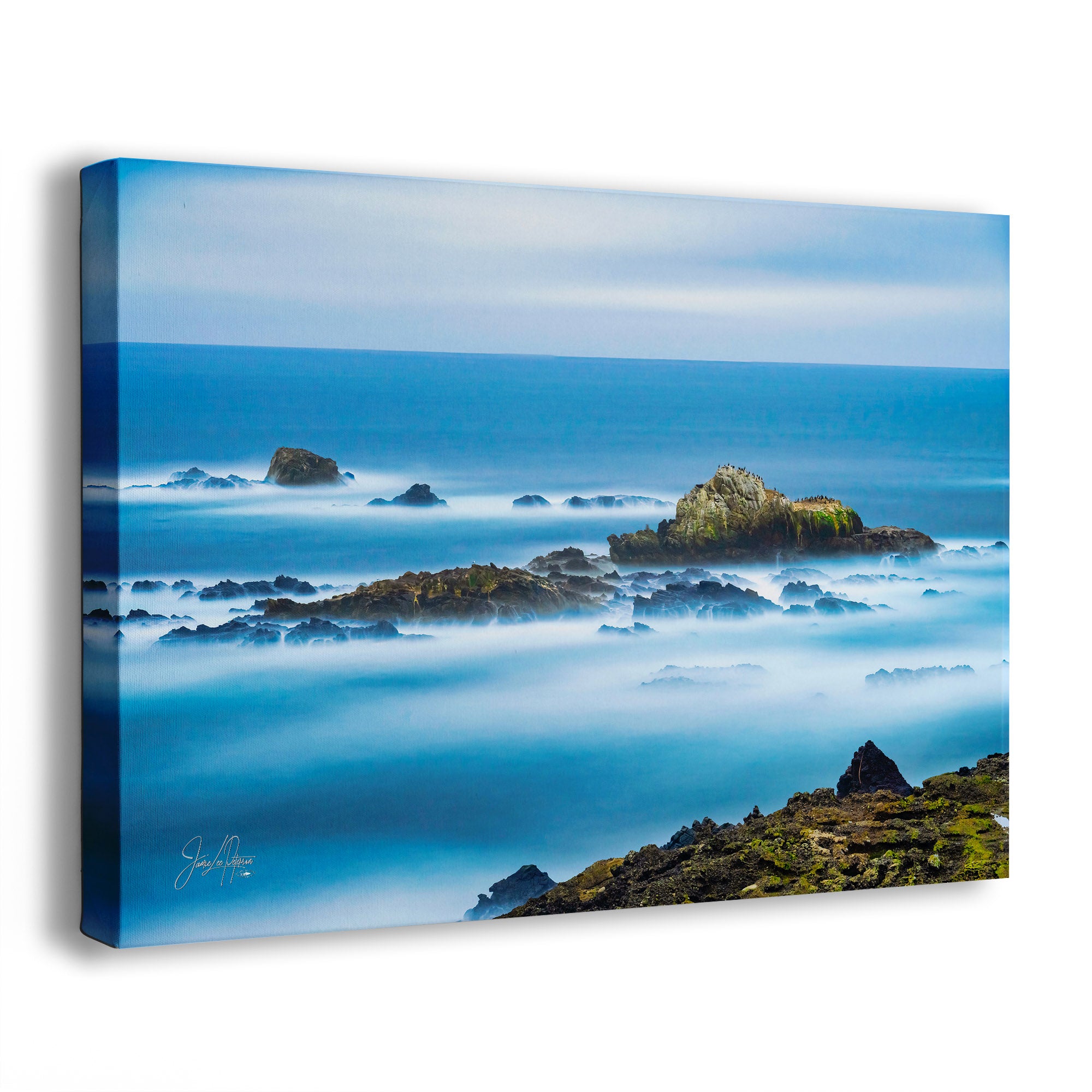 Canvas print of a calming coastal scene with rocks and ocean.