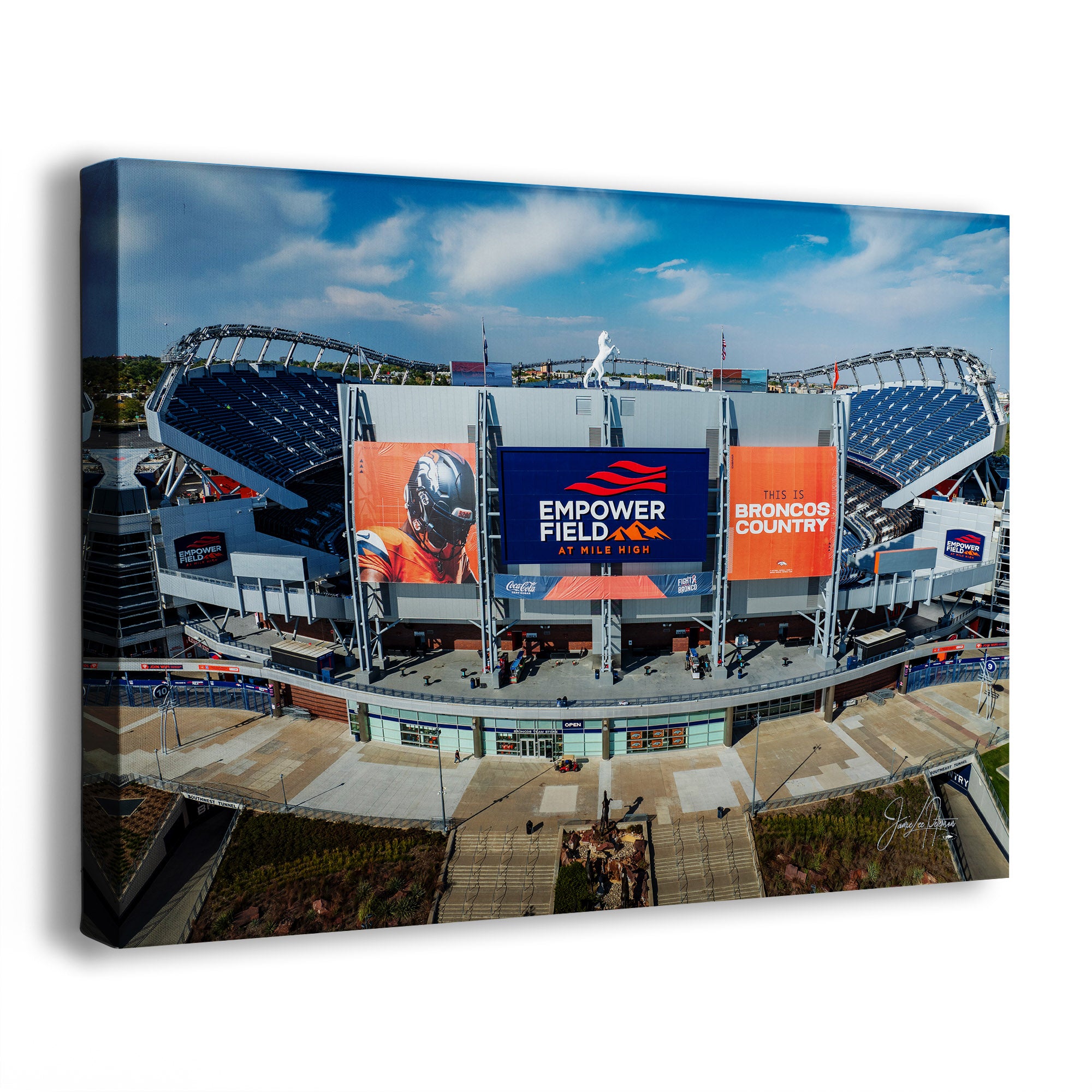 A canvas Broncos Empower Field wall art print showing an aerial view of a stadium with large 'EMPOWER FIELD AT MILE HIGH' billboards and 'BRONCOS COUNTRY' signage, photographed against a plain white background.
