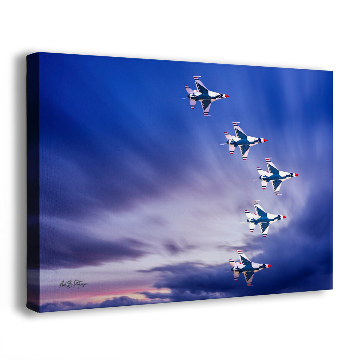 A wall art print depicting five fighter jets flying in a V formation against a dramatic blue-and-purple sky with clouds. The print is photographed at a slight angle on a clean white background.
