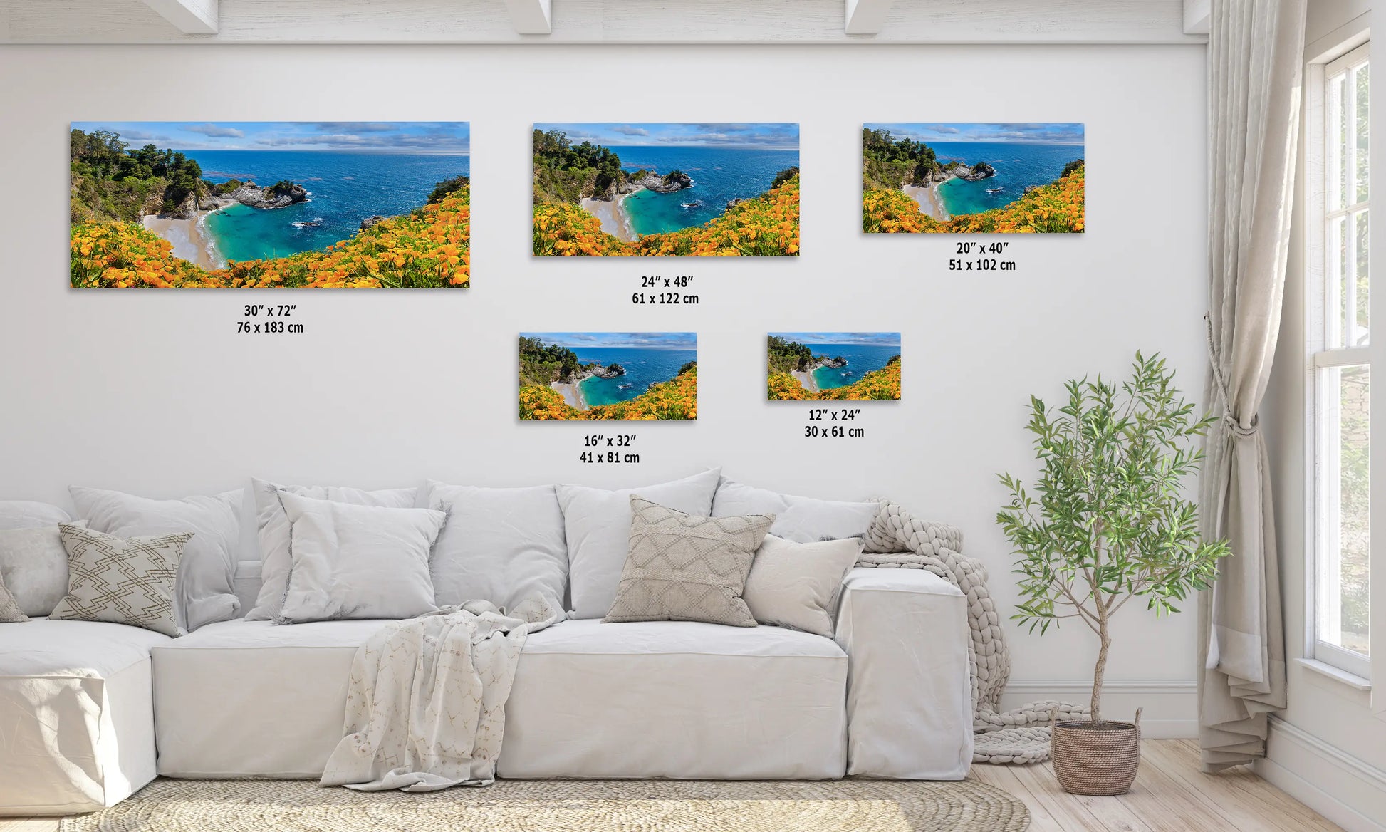 a living room with a white couch and four pictures on the wall