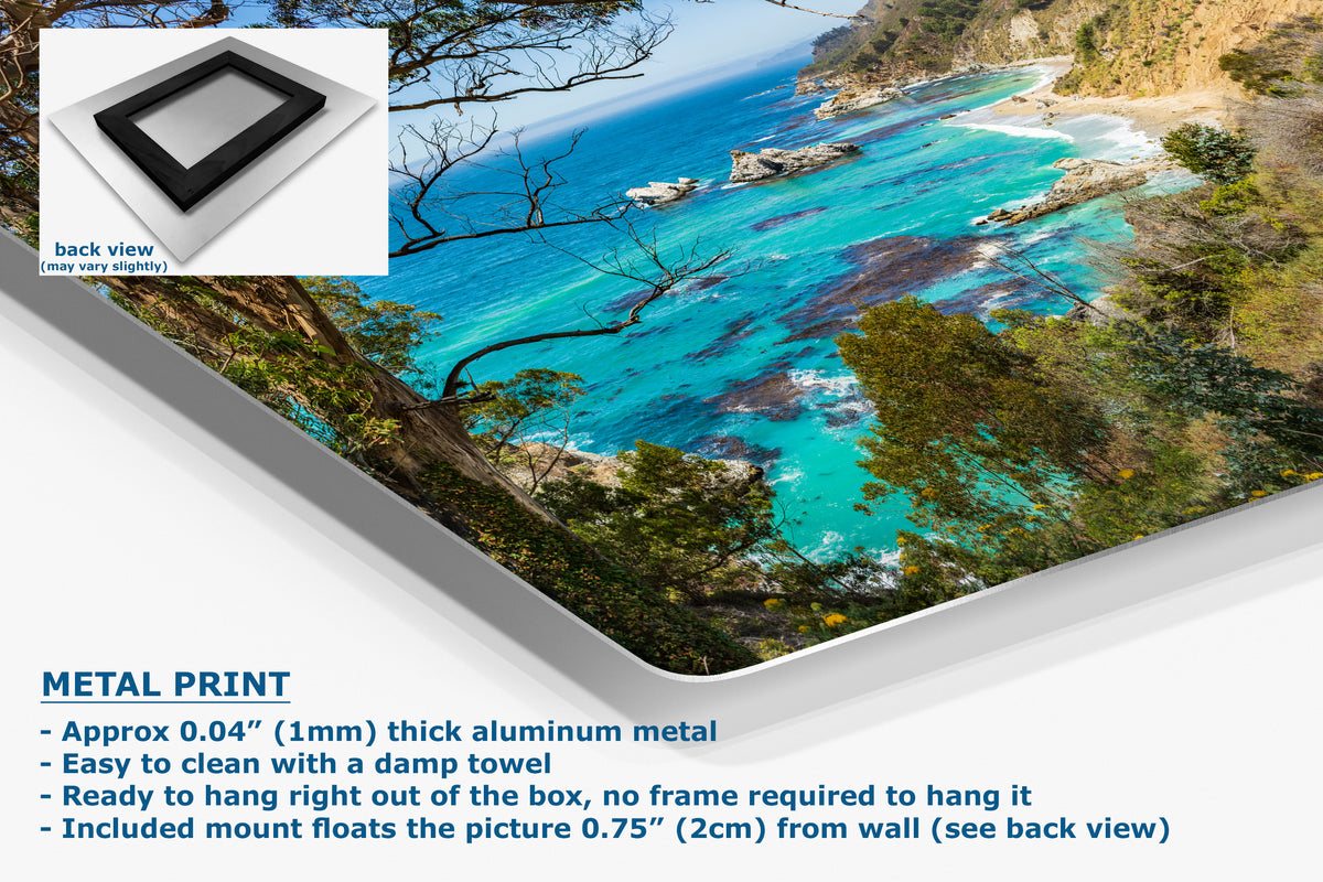 A corner angle of a metal art print sample featuring a vivid coastal landscape with a turquoise ocean, rocky shoreline, and trees, presented on a white background, with a small inset showing the back of the product and text describing the metal print's features.