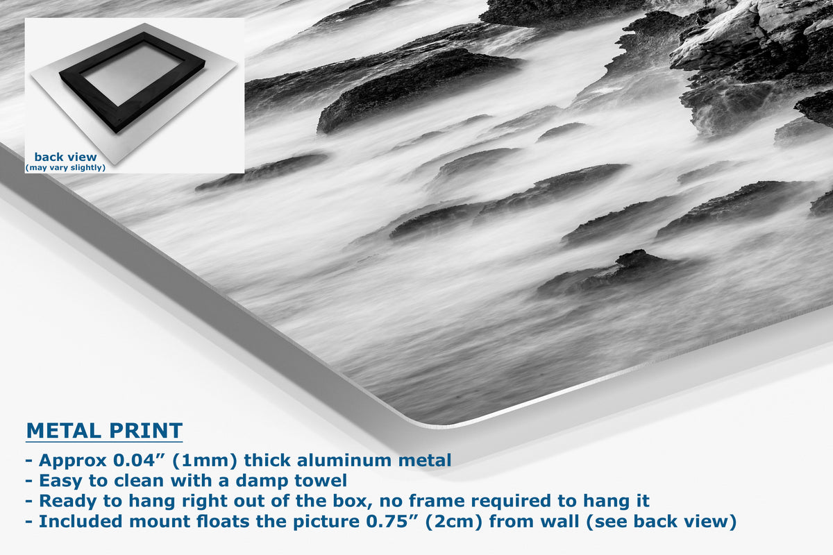 Black and white metal wall art print featuring a dramatic rocky landscape with flowing water, shown at an angle with product details and text on a white background.