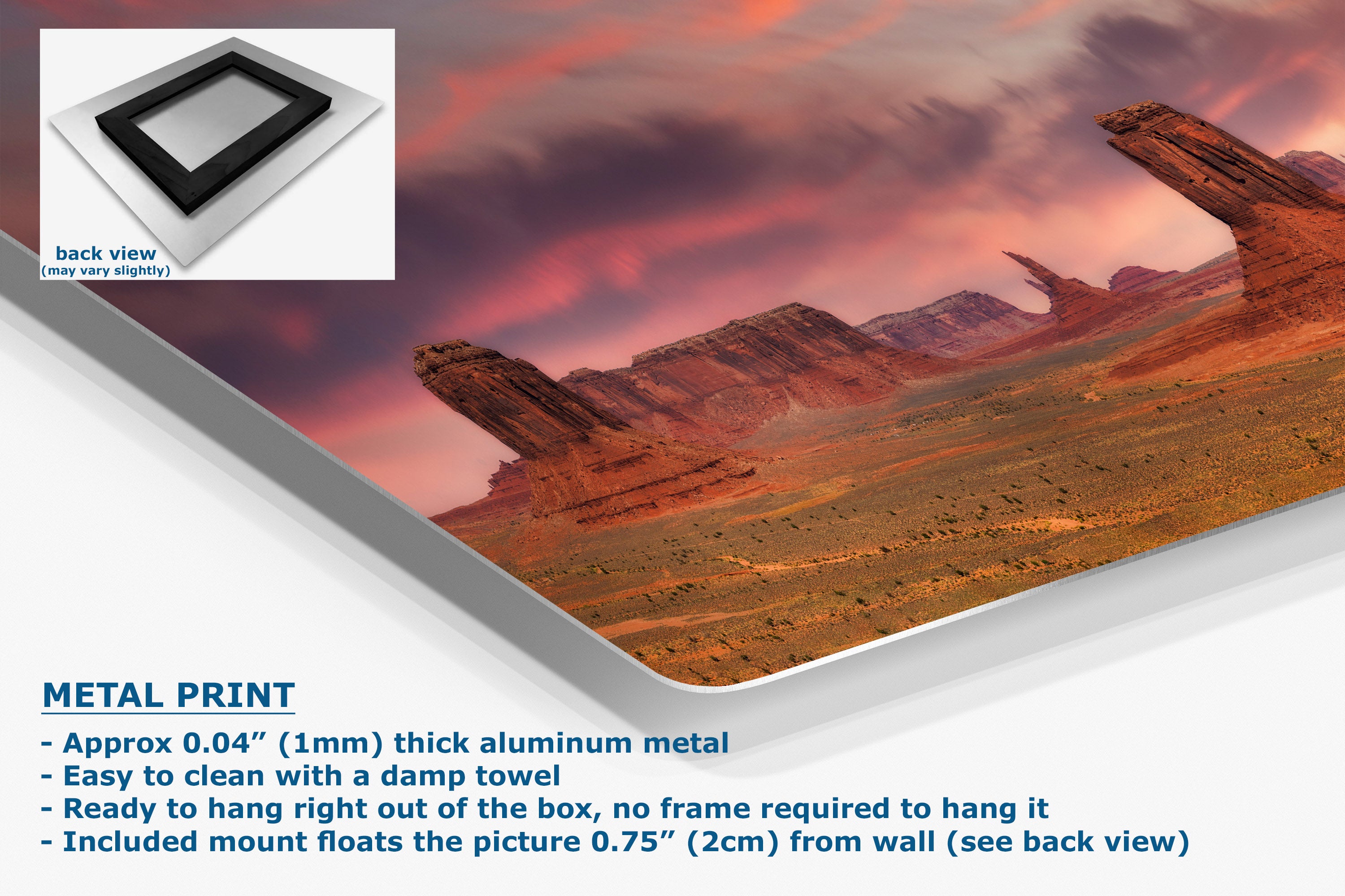 A metal wall art print showing a desert landscape under a pink and purple sky, displayed at an angle with a small inset showing the back view.