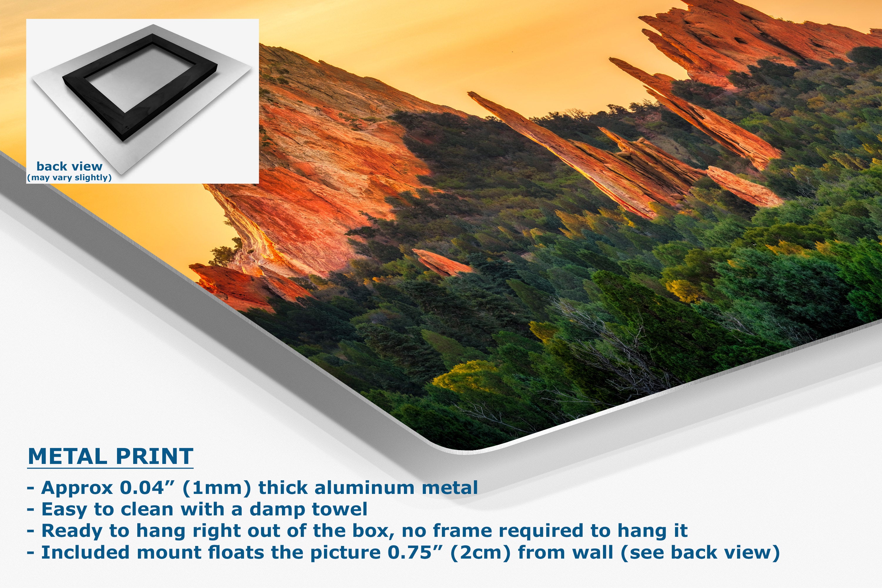 A corner view of a metal wall art print showing a desert canyon landscape with orange rock formations and green trees, displayed at an angle with product text and a small back-view inset on a white background.