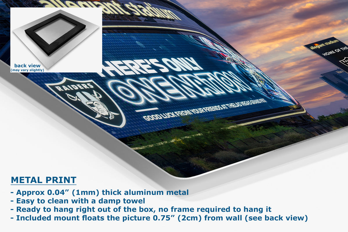 A corner view of an aluminum metal wall art print displaying a Raider graphic with the text 'THERE'S ONLY ONE NATION' and a Raiders shield logo. The image includes a small inset showing the back view of the sign, plus marketing text at the bottom describing the aluminum finish and mounting details.