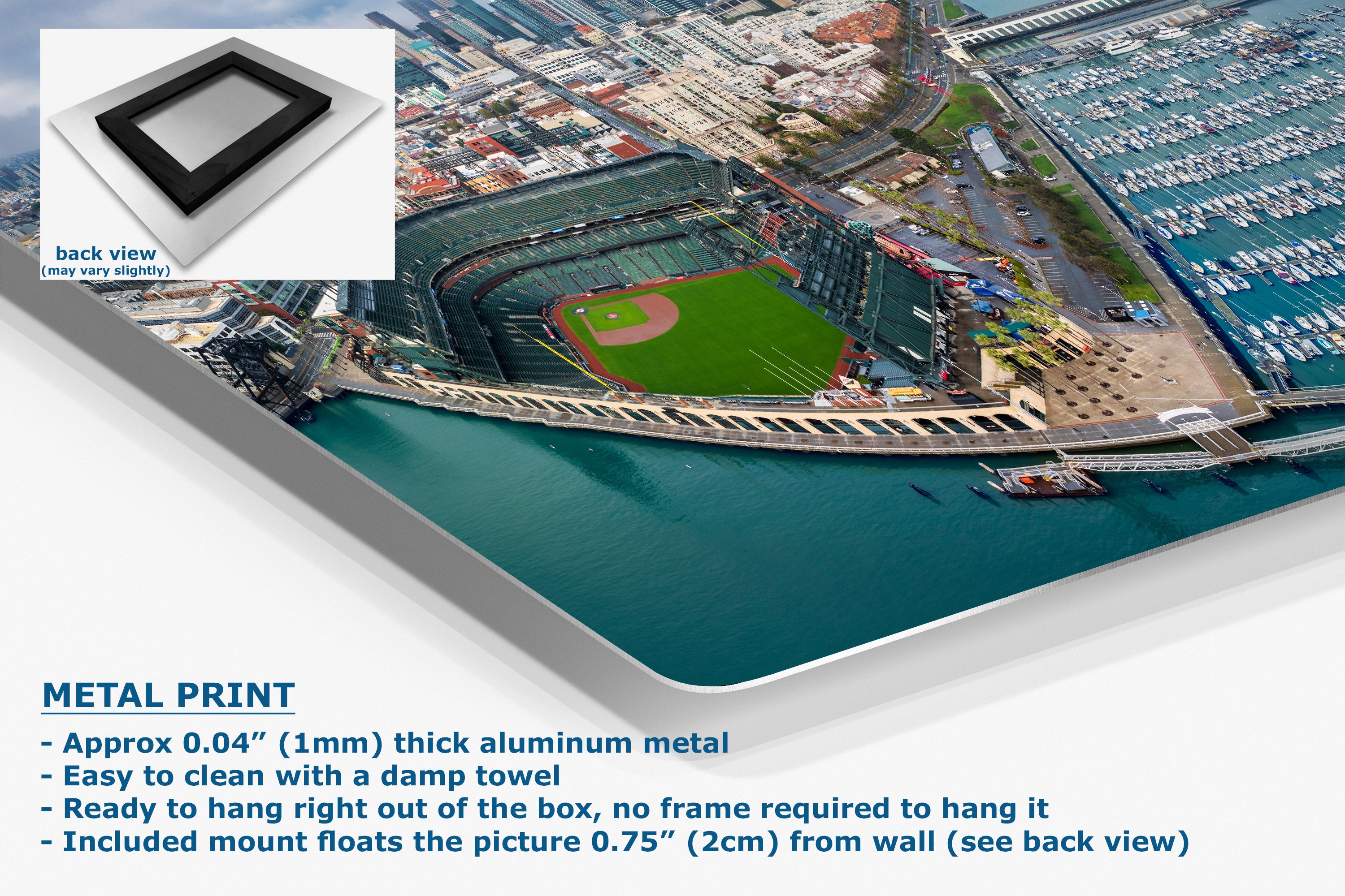 A corner view of an aluminum metal wall art print showing an aerial view of a baseball stadium by the water, with product details and a small back-view inset on a white background.