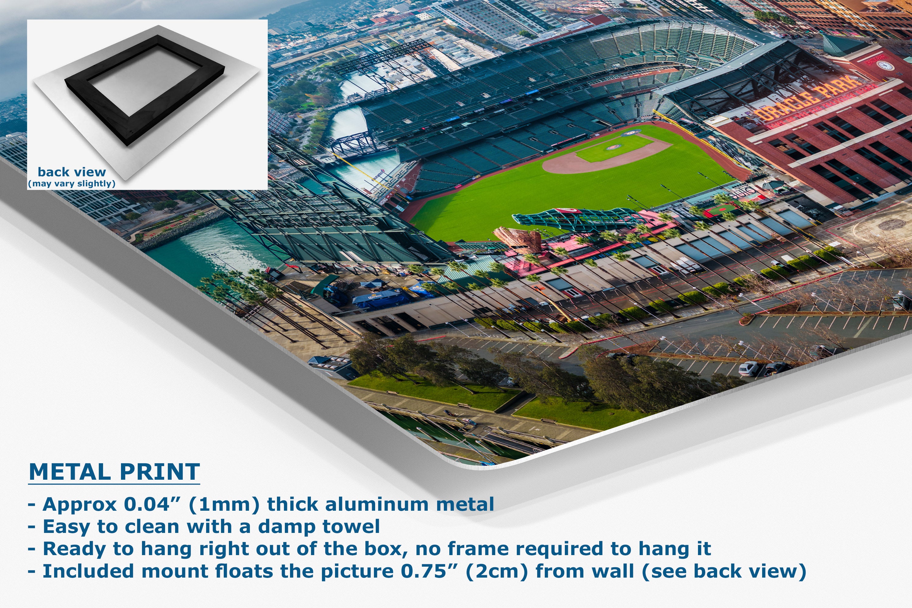 A corner view of an aluminum metal wall art print featuring an aerial photograph of a baseball stadium, shown at an angle with a white inset showing the back view and product text detailing its 0.04" thick aluminum finish.