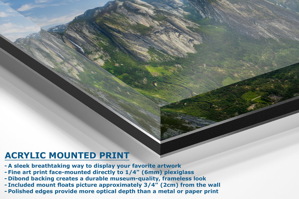 A corner view of an acrylic mounted art print showing a mountain landscape with descriptive text highlighting its frameless, edge-polished display quality.