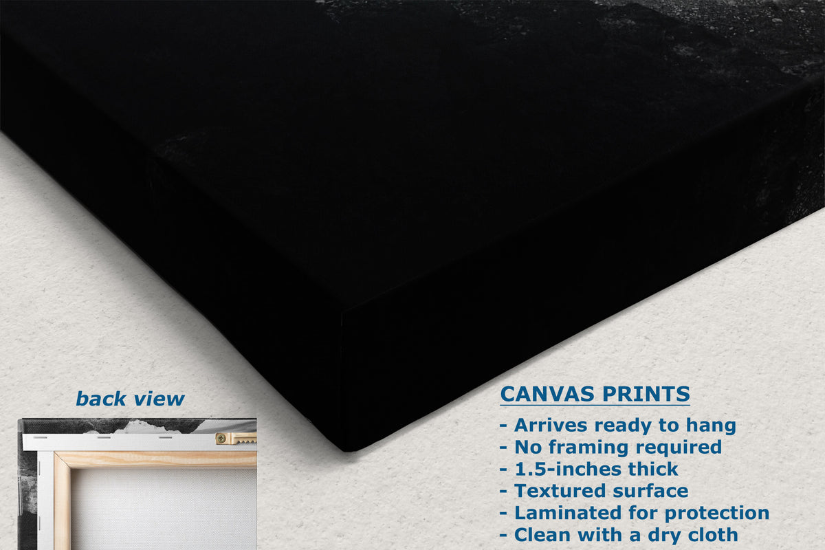 Black canvas wall art shown at an angle on a light textured background, with text describing canvas print features and a small inset labeled back view showing a framed presentation option.