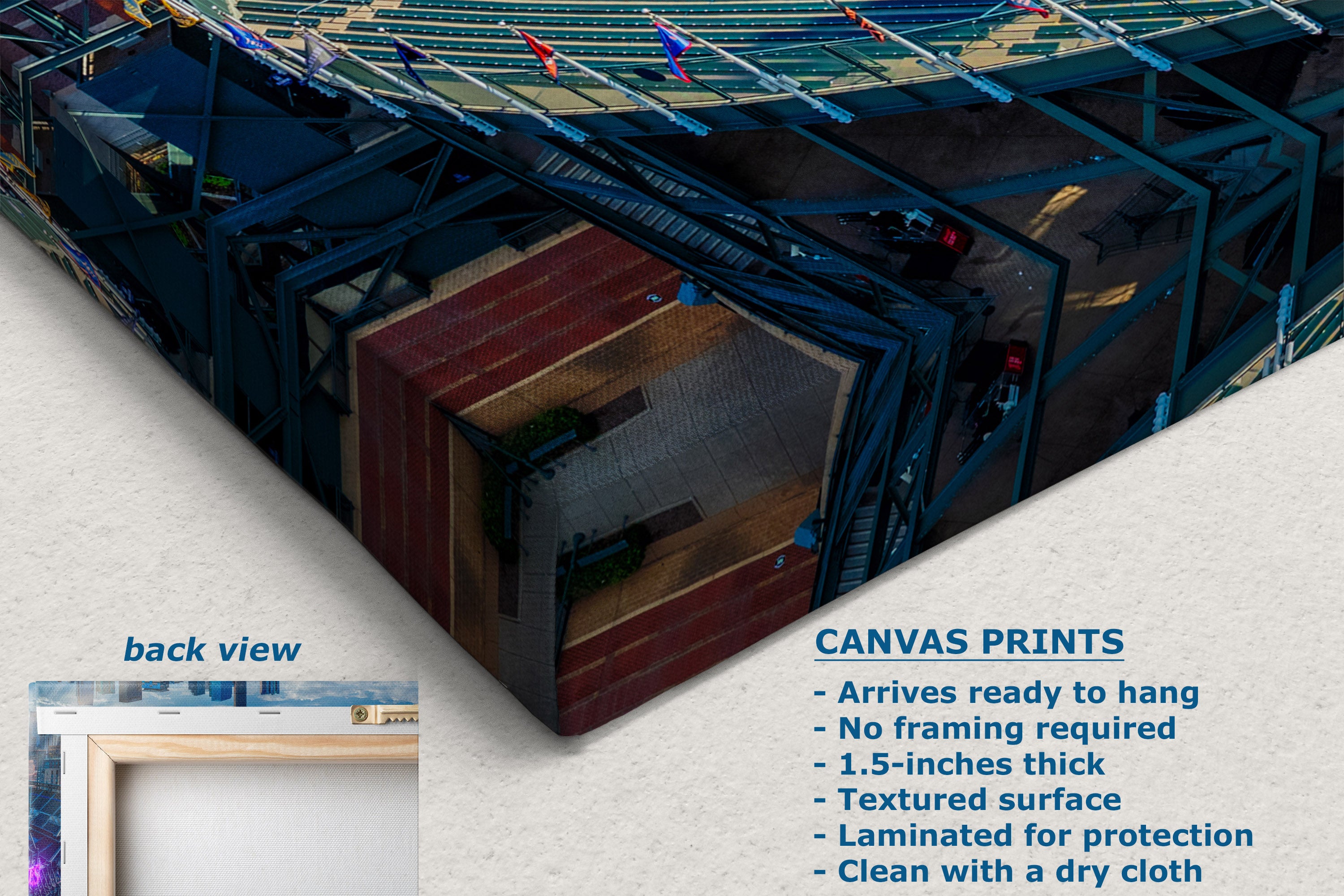 A corner view of a canvas wall art print shown at an angle with a text callout describing features and a small inset labeled back view. The artwork depicts a stadium-like scene with blue seating, green field elements, and a reddish-brown central structure.