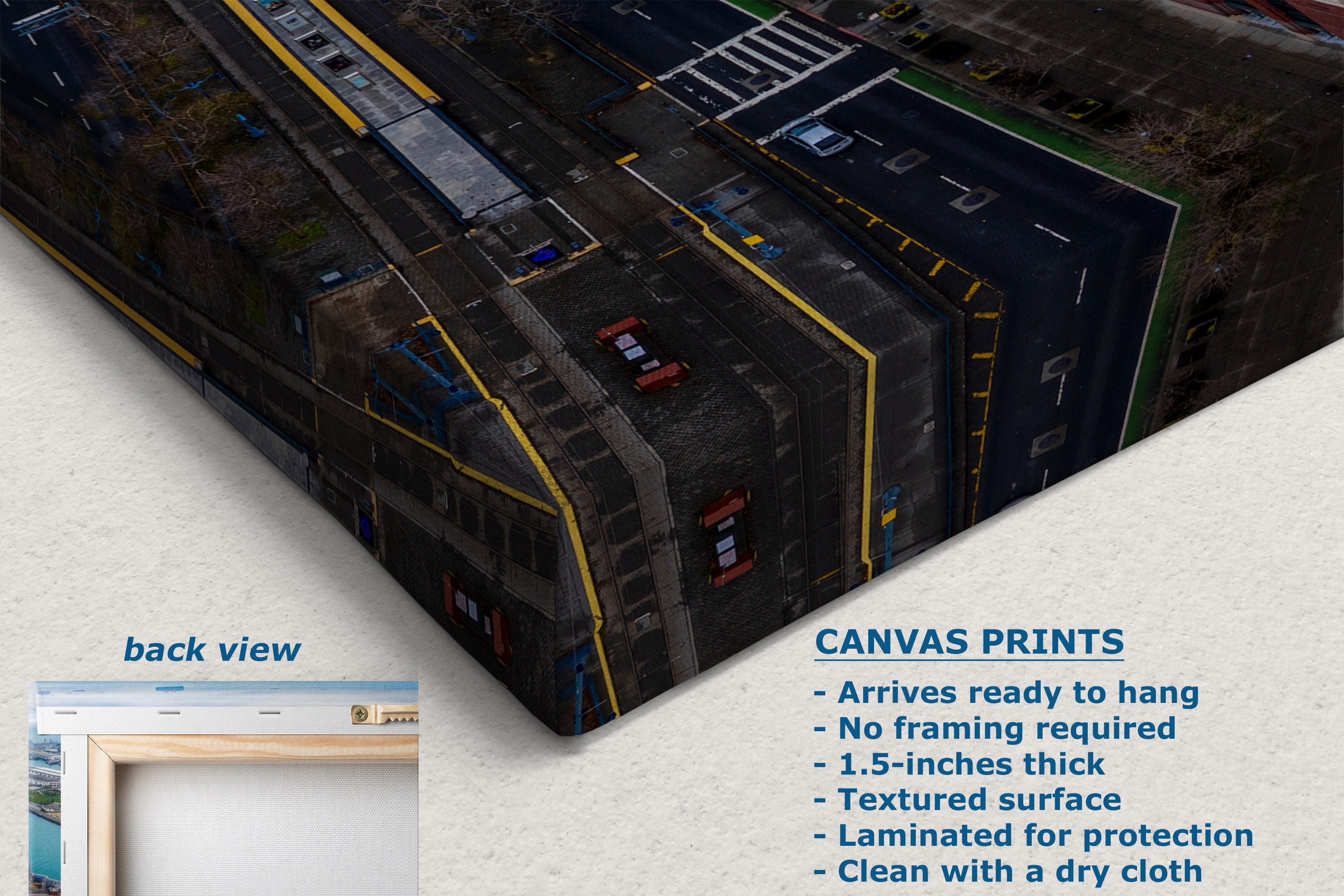 A corner view of a canvas wall art print shown at an angle with a text panel describing features and a small inset labeled back view. The print depicts an aerial street scene with dark roads, yellow lines, and small red vehicles.