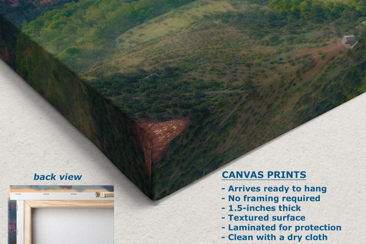 A corner view of a canvas wall art print showing a green hillside landscape, displayed at an angle on a light textured background. The image includes a small inset labeled 'back view' and text describing the product as a textured canvas print.