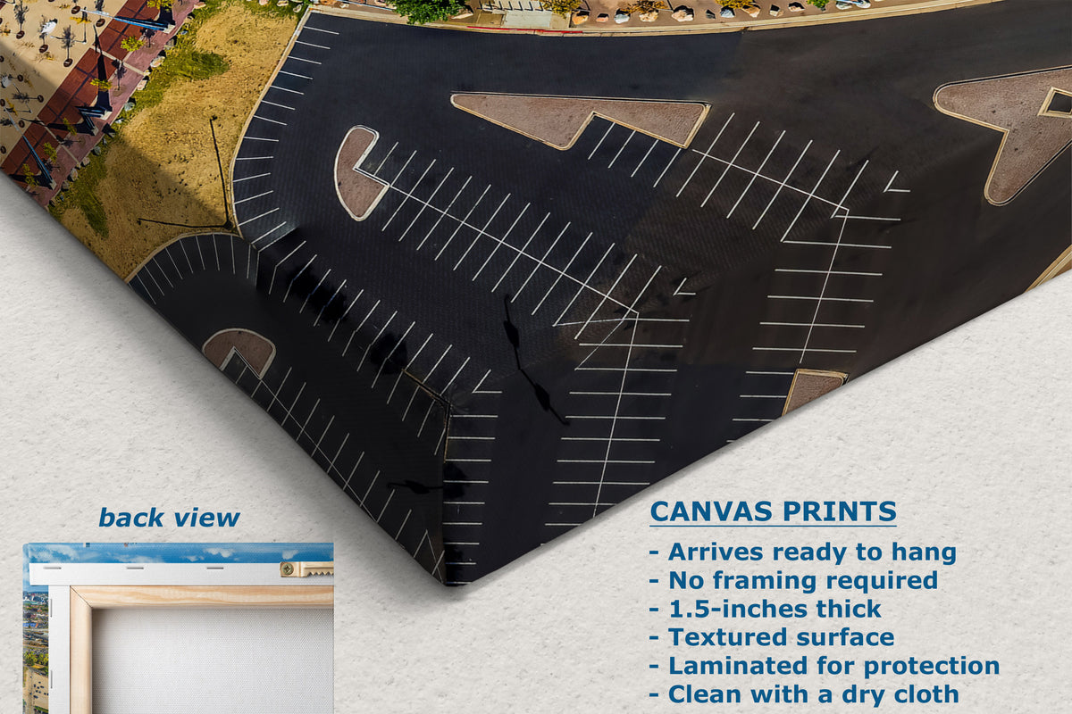 A corner view of a canvas print showing an aerial view of a parking lot, displayed on a textured white background with text describing the product features and a small inset labeled 'back view'.
