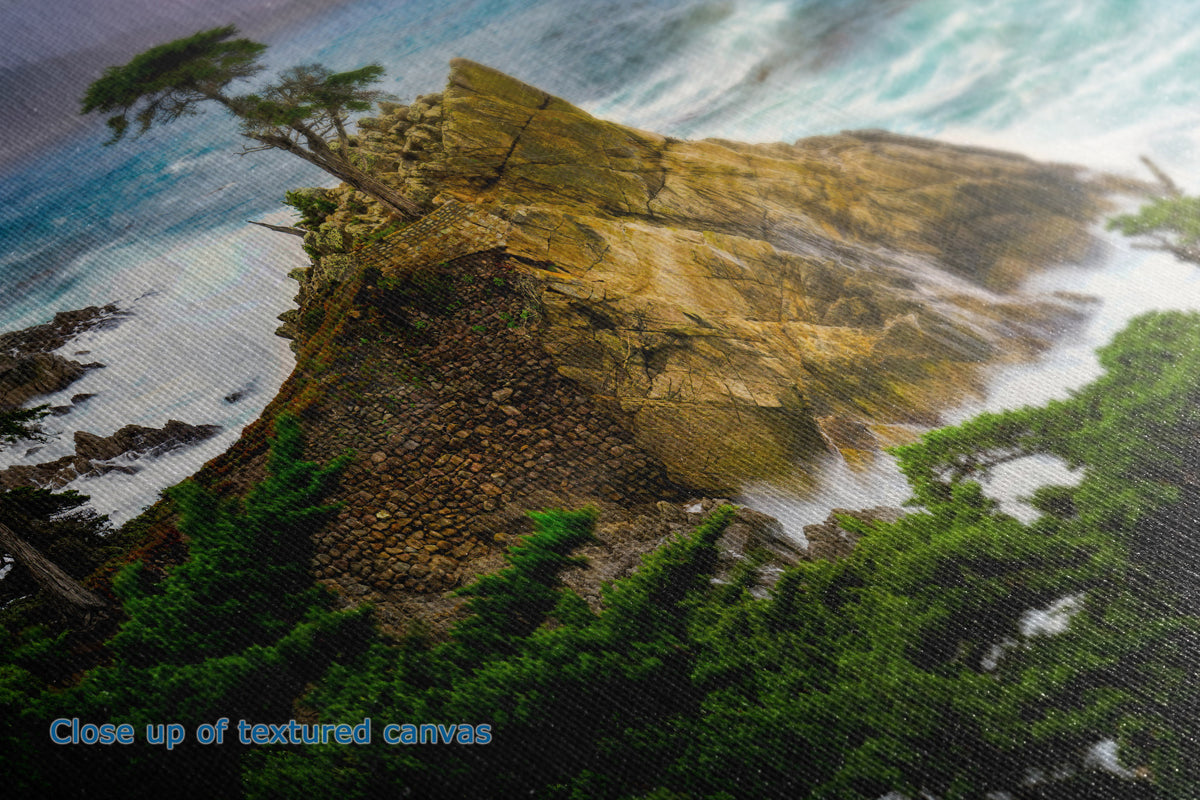 Close-up of a textured canvas print depicting a dramatic coastal cliff with crashing waves, green pine trees, and a single leaning pine tree on the edge, with blue text reading 'Close up of textured canvas' in the lower left.