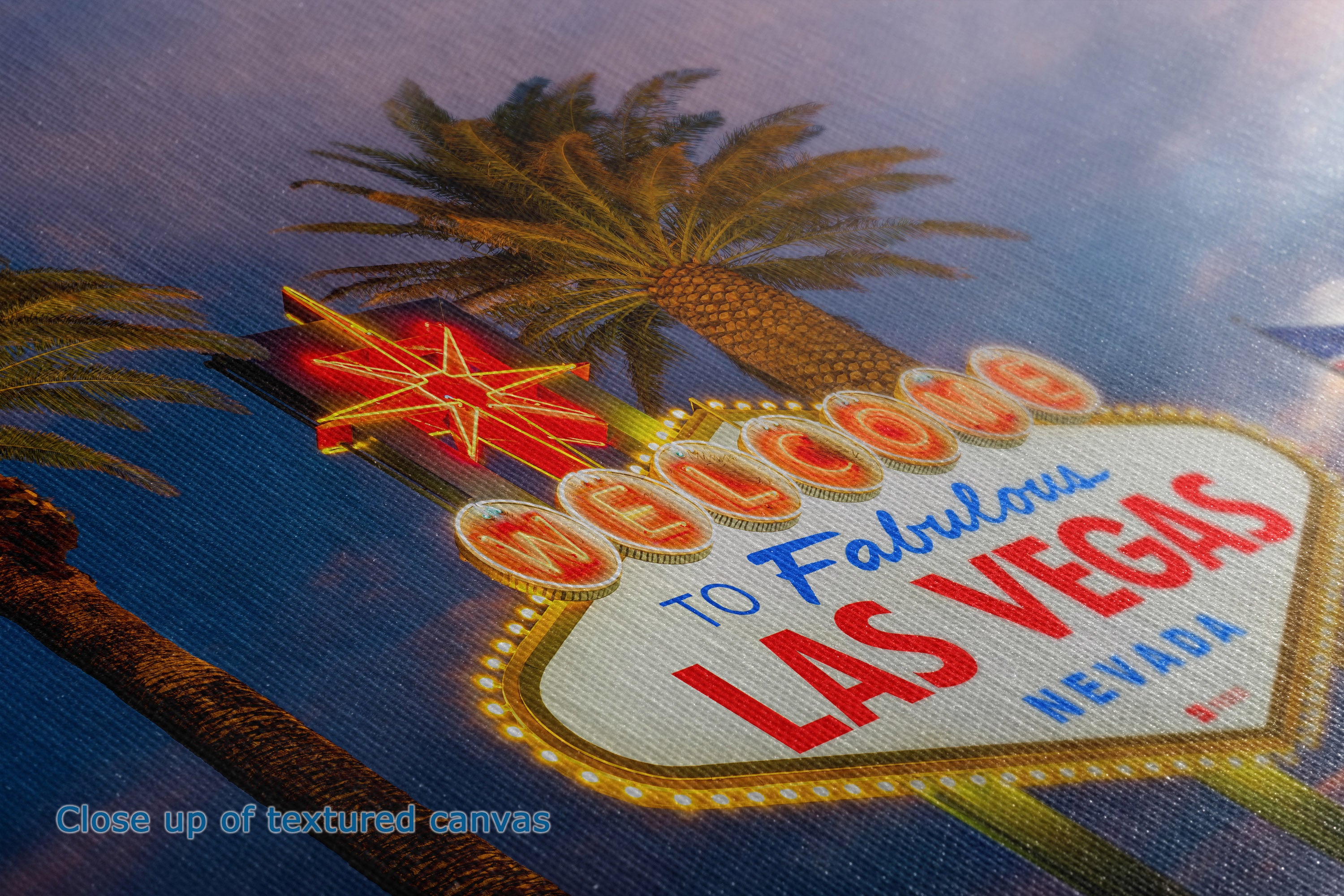Close-up of the detail and texture of a canvas print depicting the iconic 'Welcome to Fabulous Las Vegas' sign with palm trees and a blue sky background.
