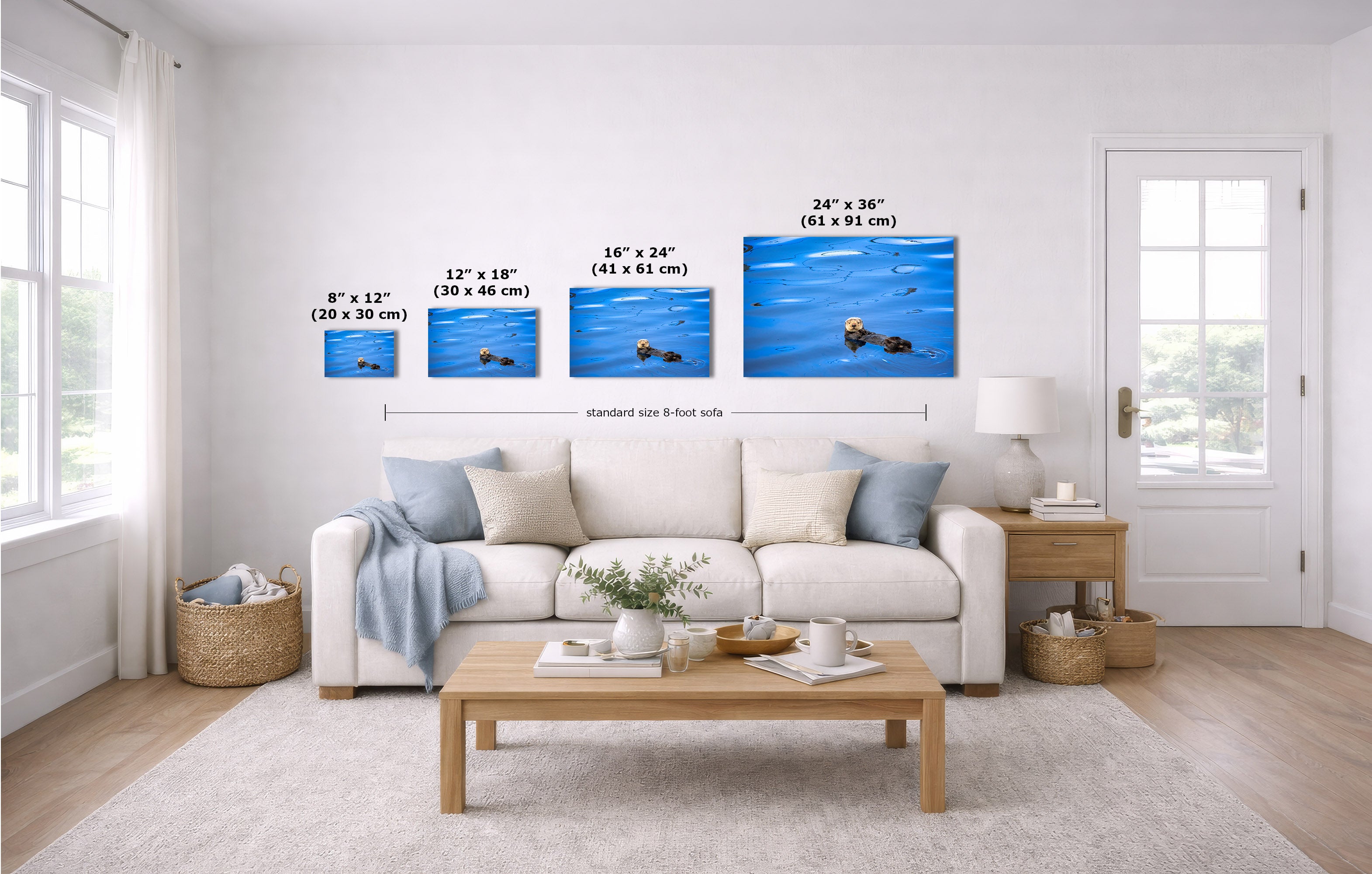 A staged living room shows a white sofa, coffee table, and wall art featuring four blue art prints with size labels overlaid: 8 x 12 in, 12 x 18 in, 16 x 24 in, and 24 x 36 in.