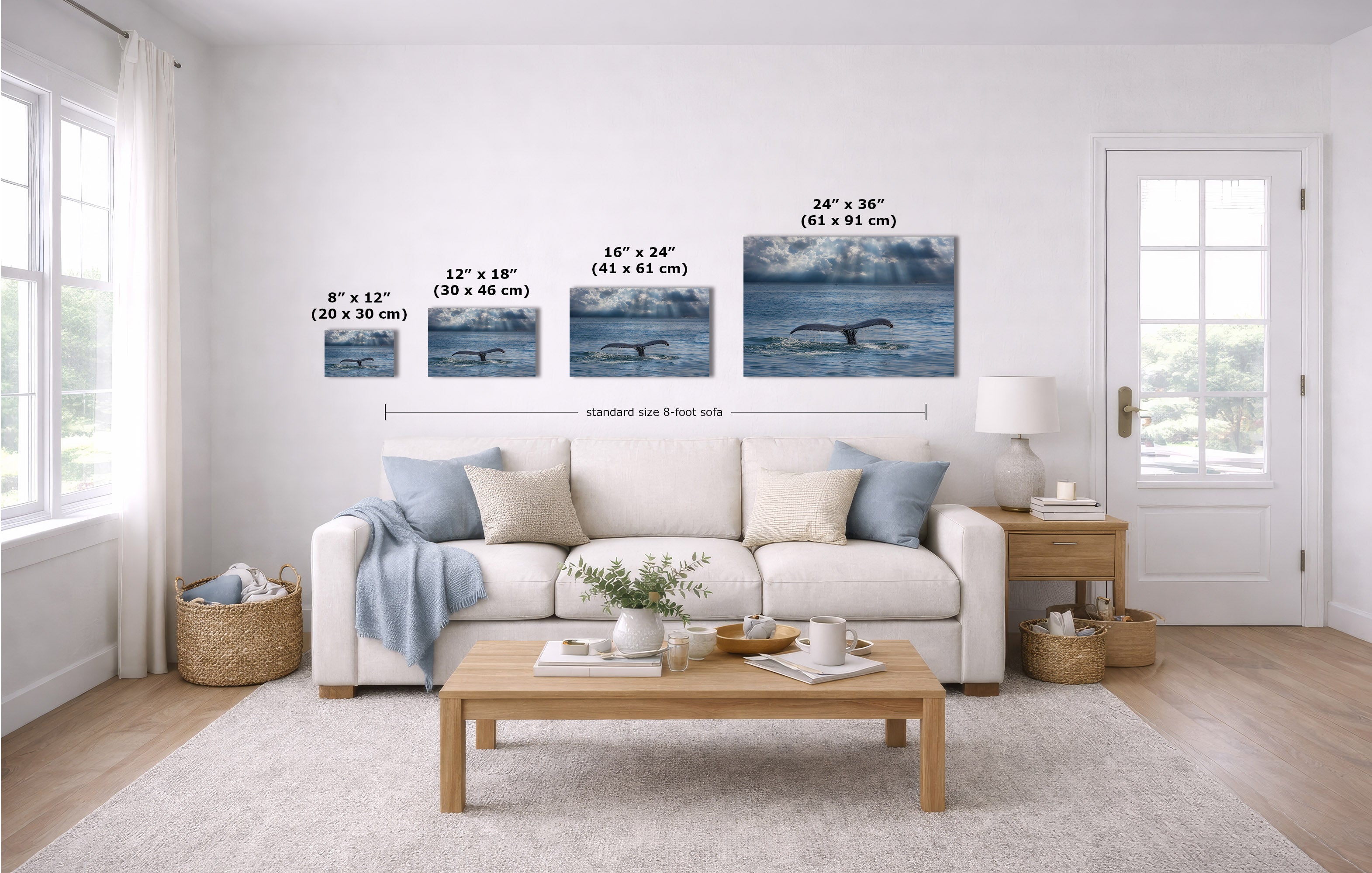 A staged living room shows a white sofa, coffee table, and wall art featuring whale ocean scenes with printed size labels and a dimension guide.