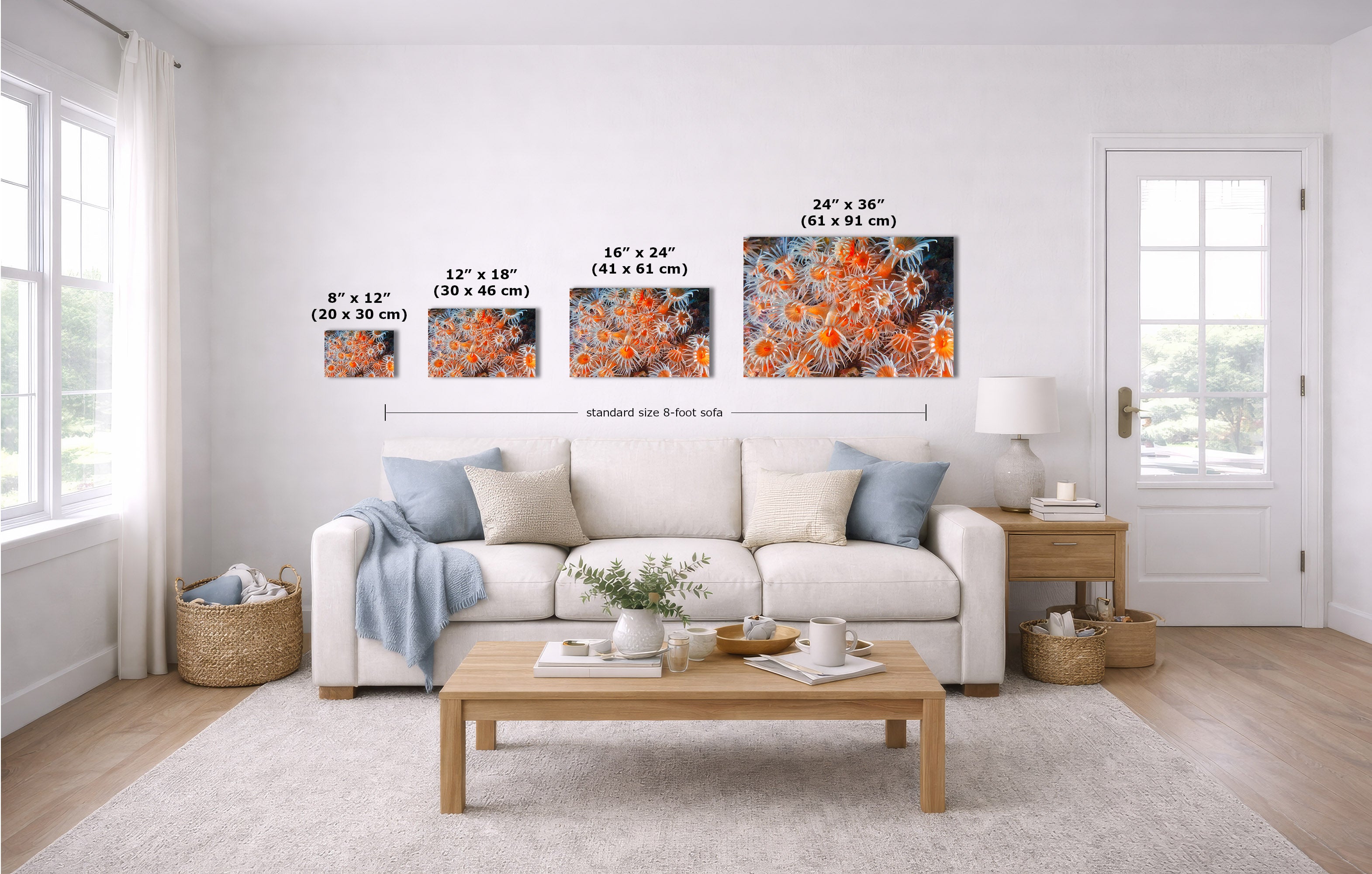 A staged living room shows four wall art prints above a white sofa, with overlaid size labels for each print. Because a real interior environment is present, this is Lifestyle rather than Product/Packaging, even though the art is the product.