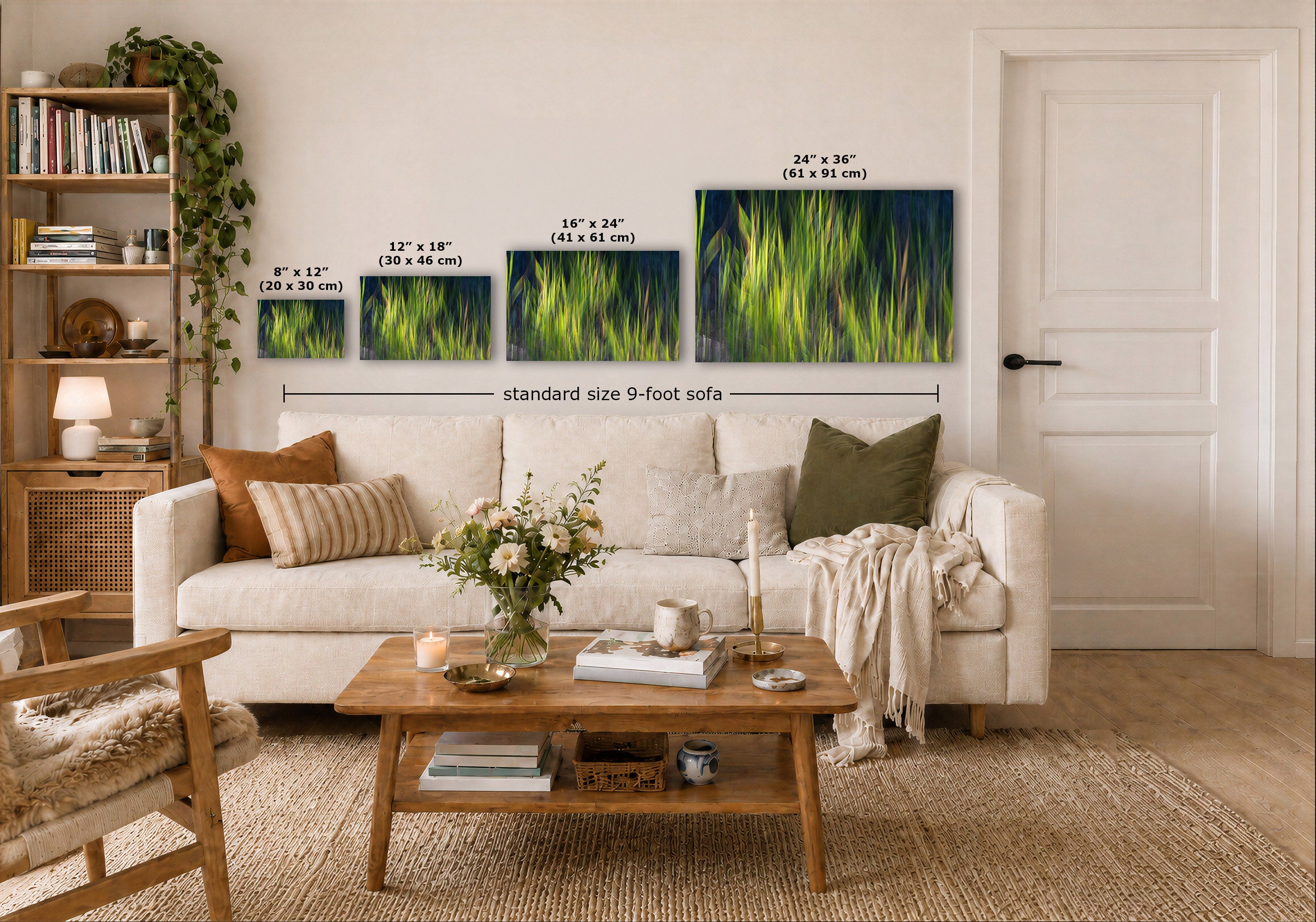 A styled living room showing four framed vertical art prints with grassy green and blue abstract designs, labeled with dimensions (8 x 12, 12 x 18, 16 x 24, 24 x 36) and a 'standard size 9-foot sofa' width measurement. The prints are displayed on a beige wall above a white sofa.