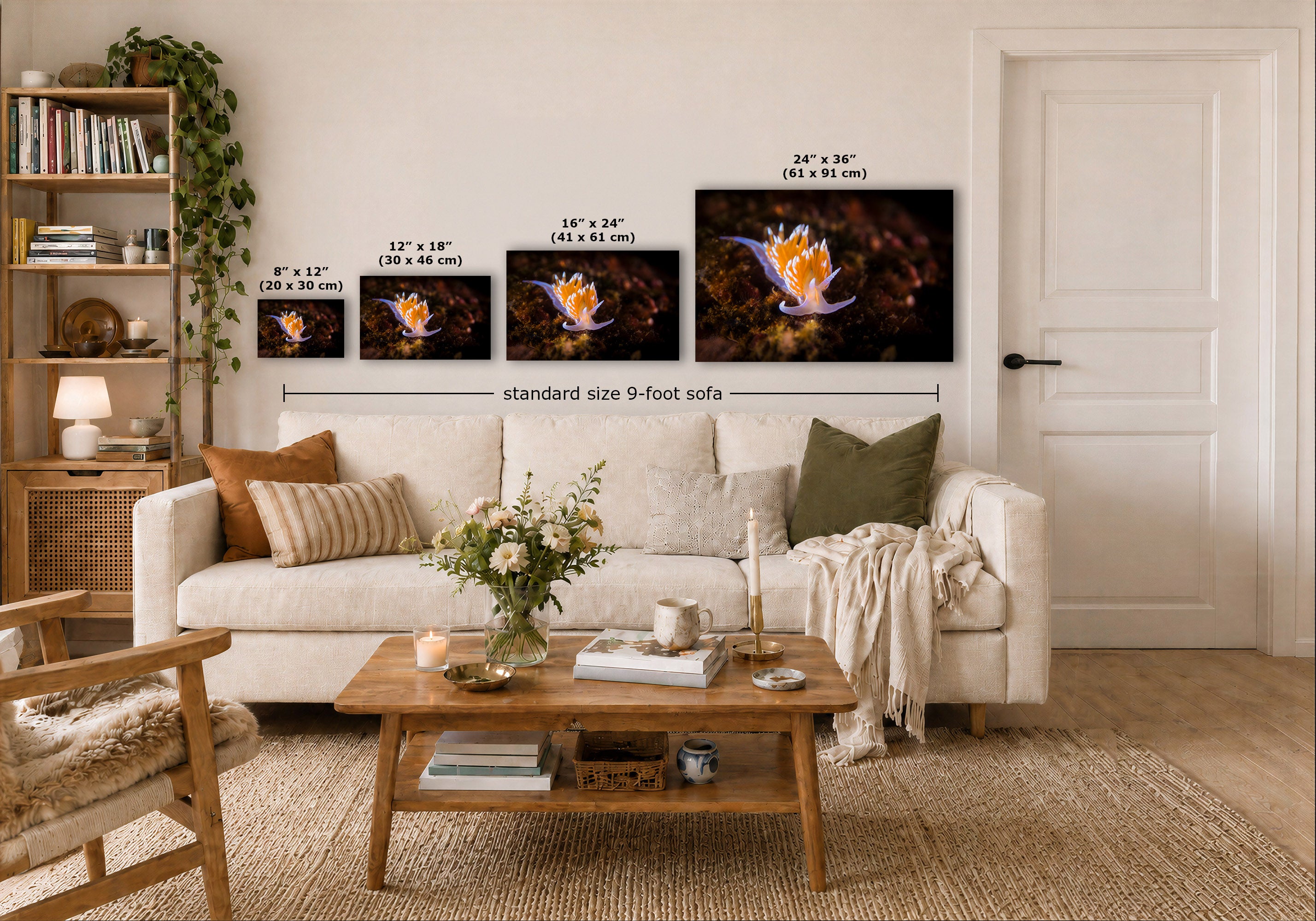 A staged living room with a white sofa, a wooden coffee table, shelving, and a wall display of four wall art prints showing different sizes of a colorful underwater artwork. Text labels indicate the sizes of each print and note a 9-foot sofa below.