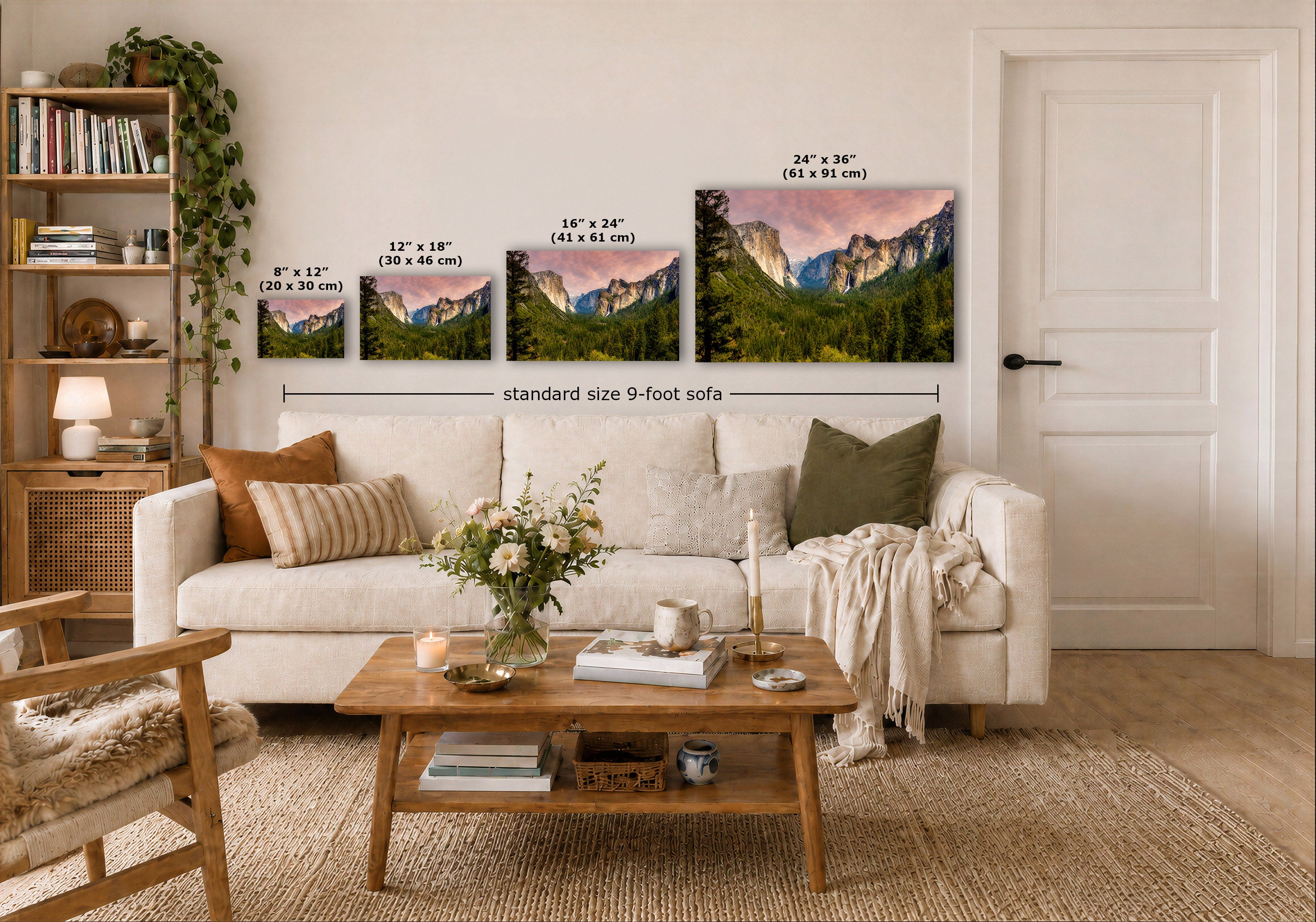 A staged living room shows a white sofa, wooden coffee table, shelving, and a wall with three framed mountain landscape prints. Black dimension lines and text label the prints in inches and centimeters, including a note for a 9-foot sofa.