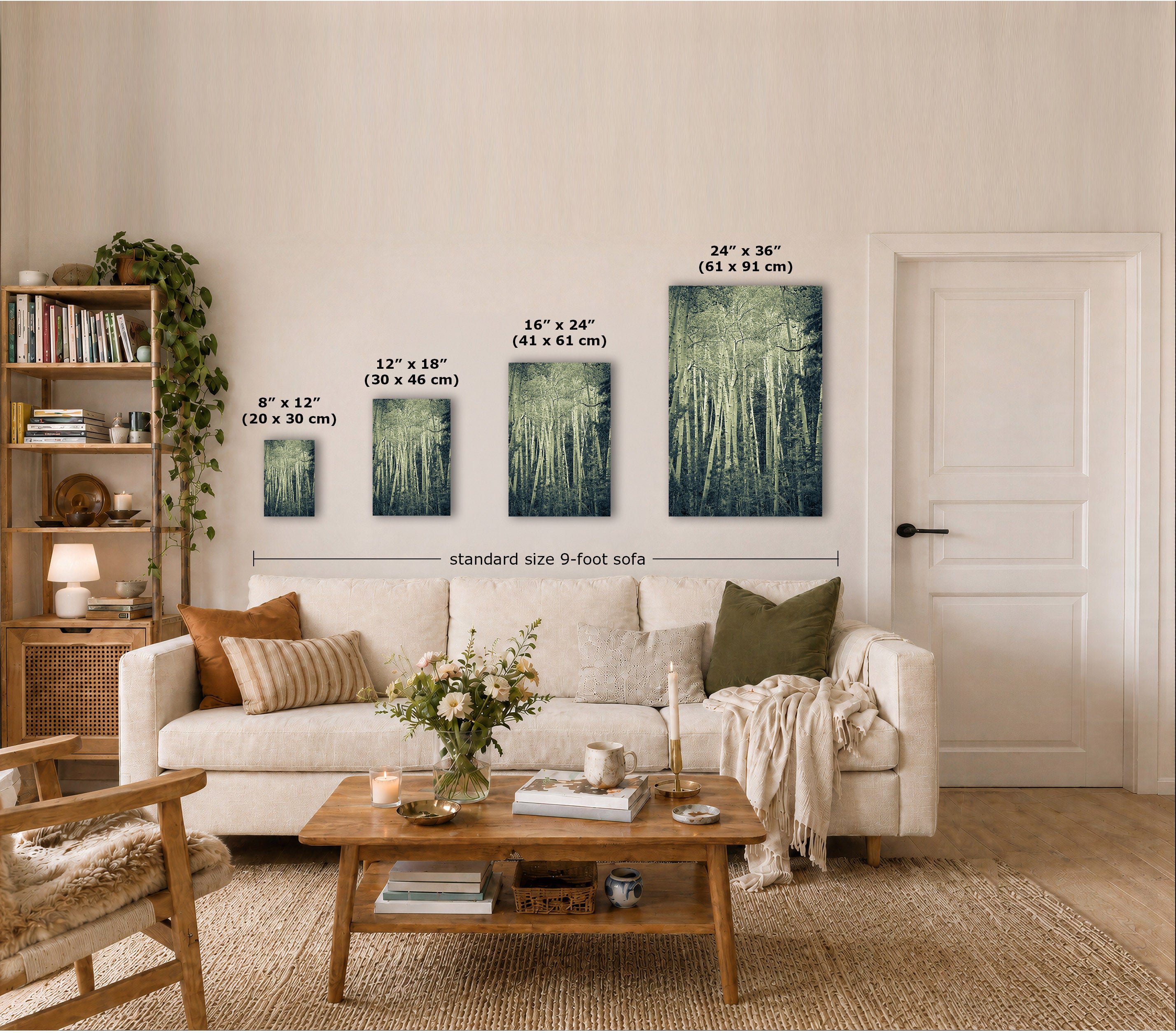 Four vertical landscape canvas prints in different sizes displayed on a beige wall above a white sofa in a styled living room. Each canvas shows a colorful scenic painting with water, trees, and sky.