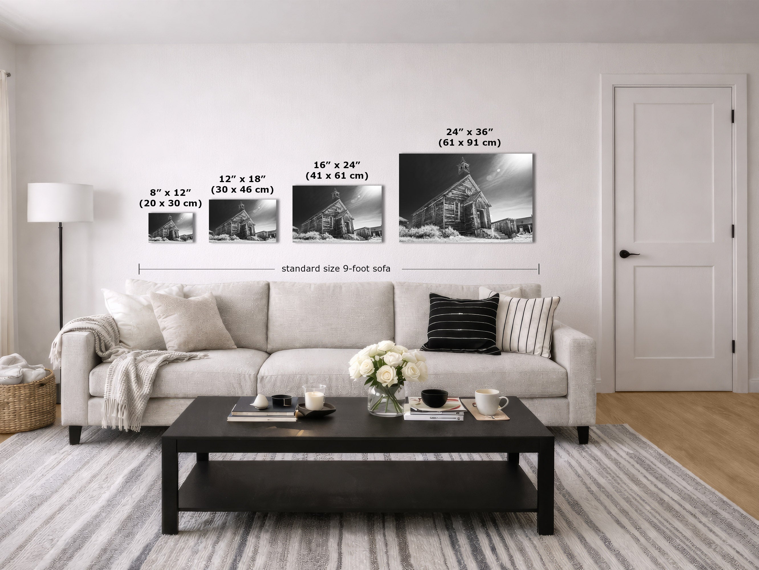 A staged living room showing four black-and-white wall art prints above a sofa, with size labels and measurements for each print. The prints depict a snowy church scene in different sizes: 8 x 12, 12 x 18, 16 x 24, and 24 x 36 inches.