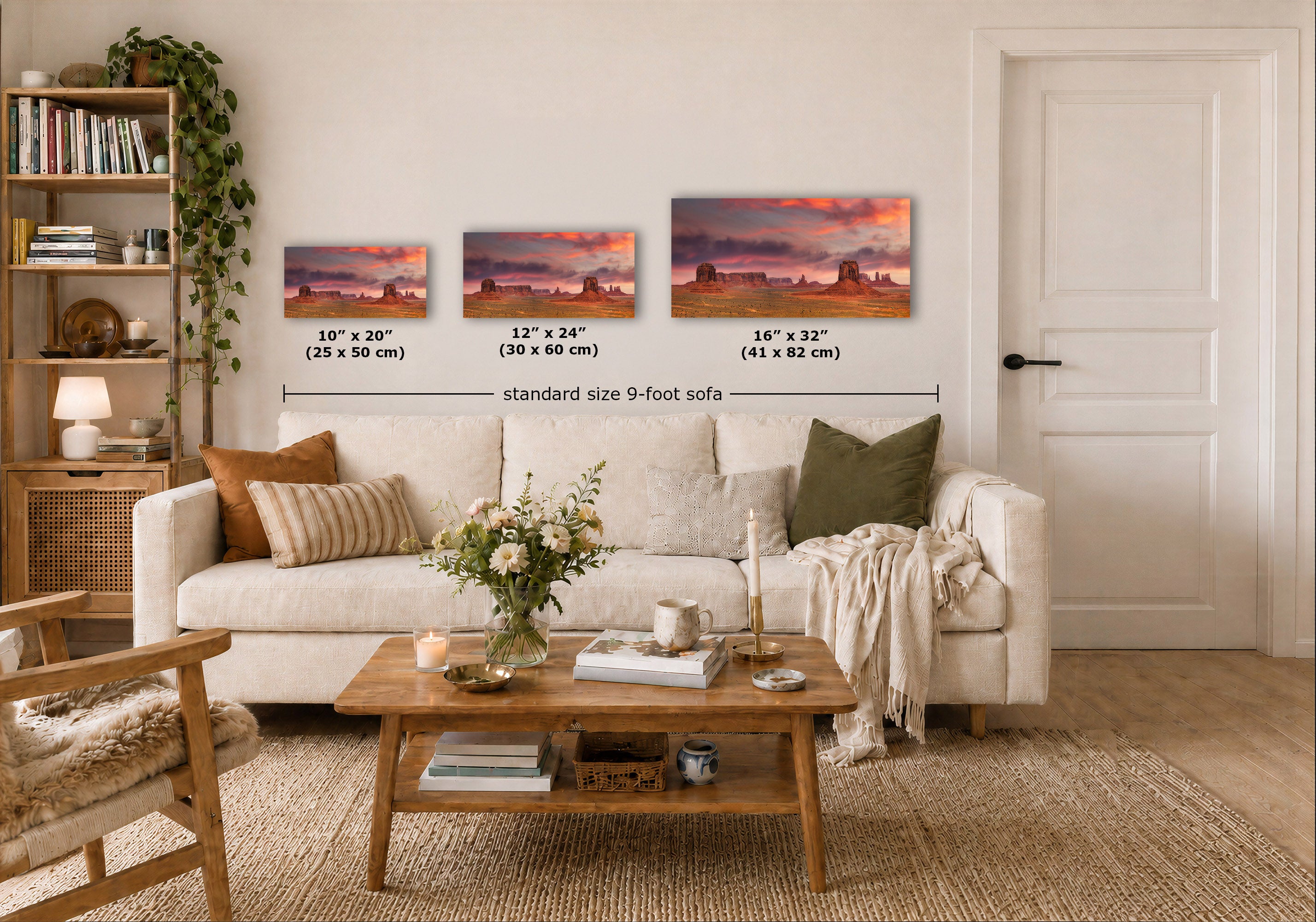 Three horizontal landscape art prints showing desert rock formations at sunset, displayed above a white sofa in a styled living room. Black text labels indicate the dimensions of each print and a total width for standard size 9-foot sofas.