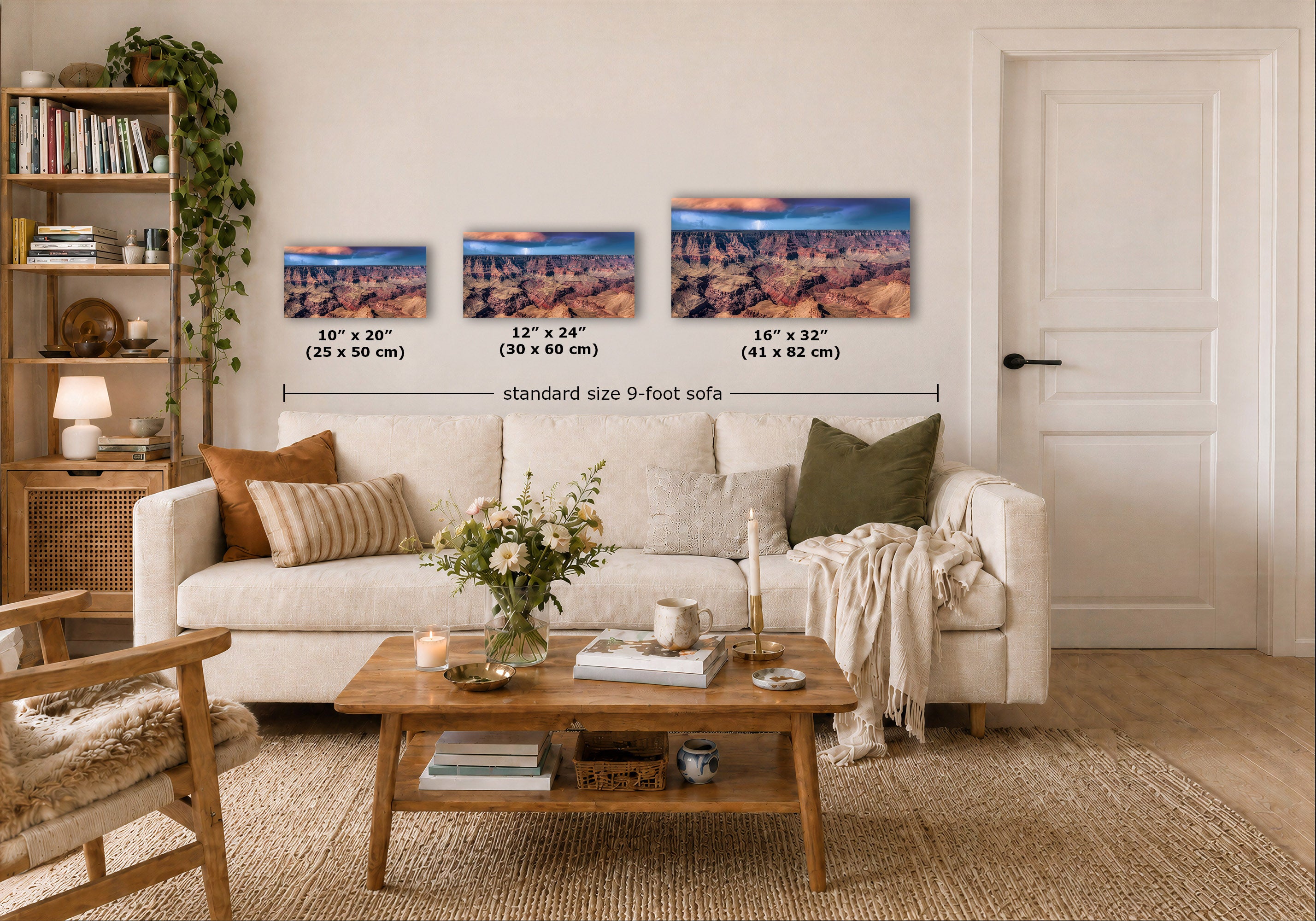 Three horizontal landscape wall art prints are displayed above a white sofa in a styled living room. Each print shows a canyon scene with blue sky, and overlaid text indicates sizes 10 x 20, 12 x 24, and 16 x 32 inches, with a dimension line reading standard size 9-foot sofa.
