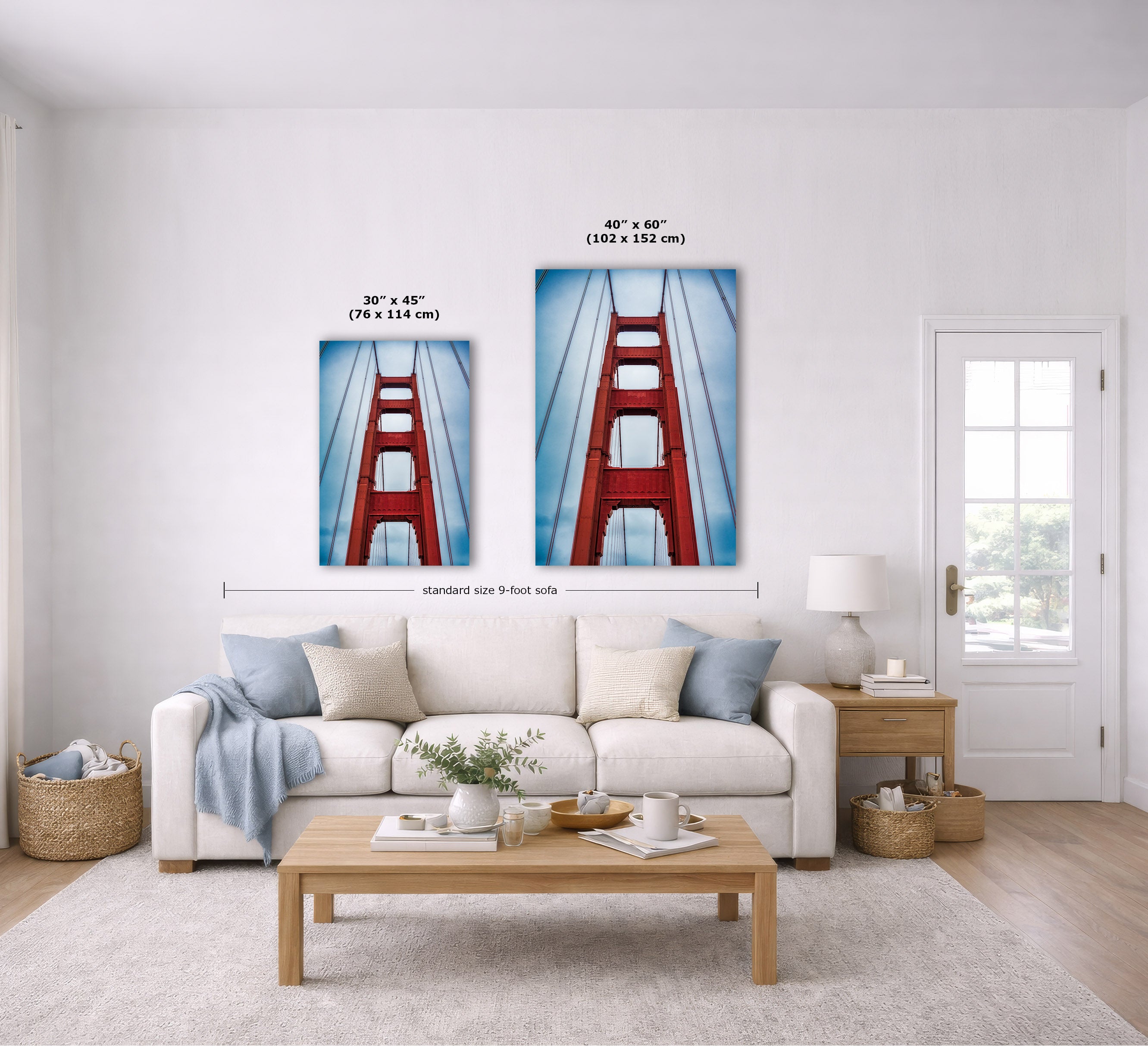 A staged living room shows two framed wall art prints above a sofa. The prints depict a red bridge tower against a blue sky, with size labels overlaid: 30 x 45 inches and 40 x 60 inches.