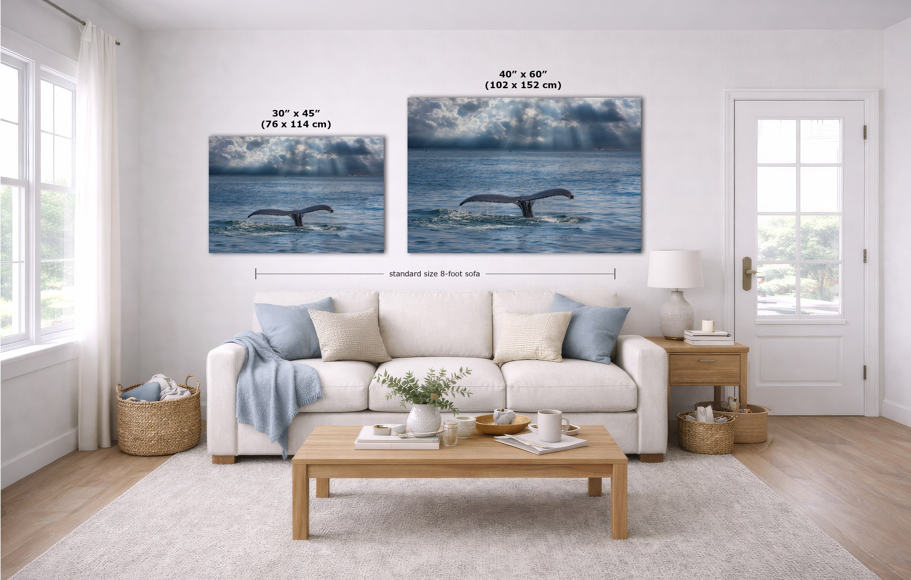 A staged living room shows two whale tail prints mounted above a white sofa, with size labels overlaid: 30 x 45 inches and 40 x 60 inches. The room includes a light wood coffee table, white rug, side table, lamp, and windows.