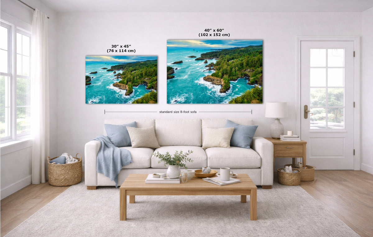 A staged living room shows two coastal landscape wall art prints above a white sofa. The left print is labeled 30 x 45 inches, and the right print is labeled 40 x 60 inches.
