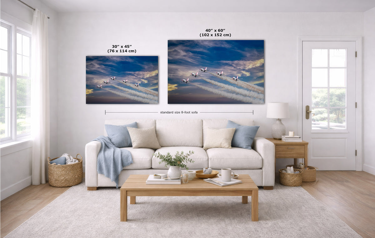 A staged living room with a white sofa, coffee table, and two wall art prints showing a blue sky with flying birds. Measurement labels indicate the dimensions of the two prints.