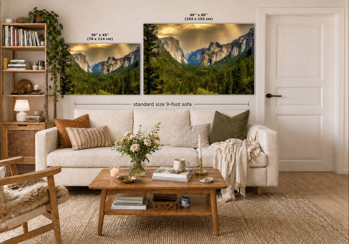 A staged living room shows two mountain landscape wall art prints above a white sofa. The left print is labeled 30 x 45 inches, and the larger right print is labeled 40 x 60 inches, with text indicating a standard size 9-foot sofa.