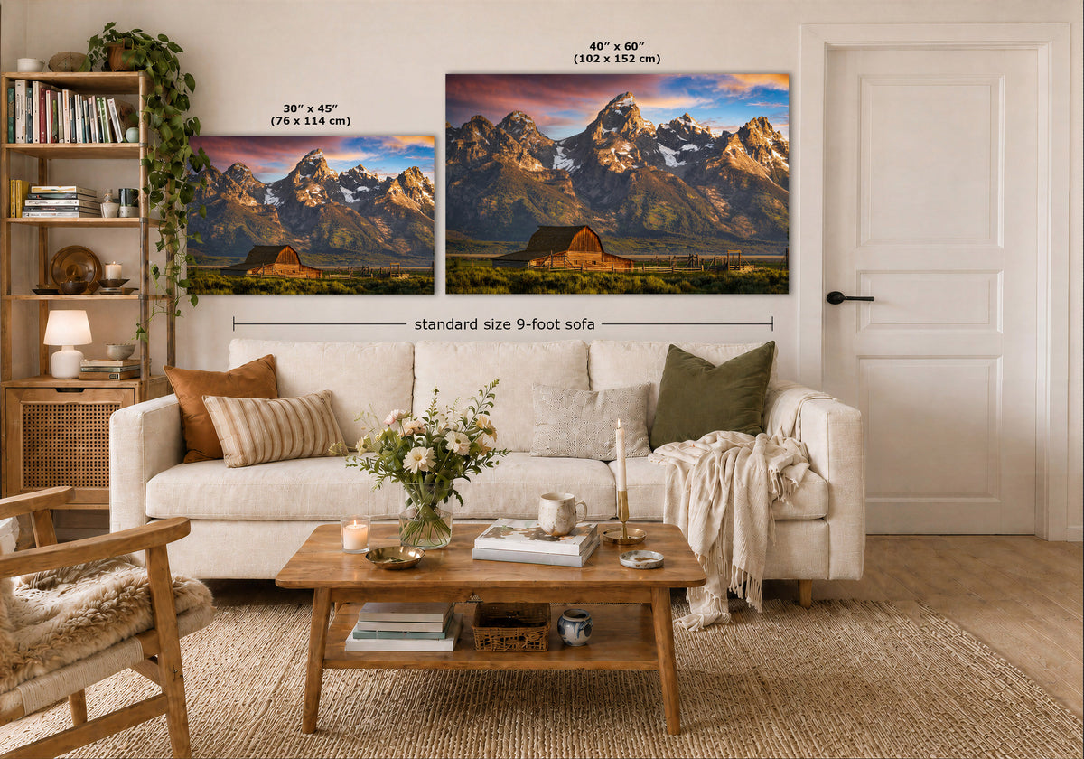 Two mountain landscape wall art prints shown above a white sofa in a styled living room. The left print is labeled 30 x 45 inches, and the larger right print is labeled 40 x 60 inches.