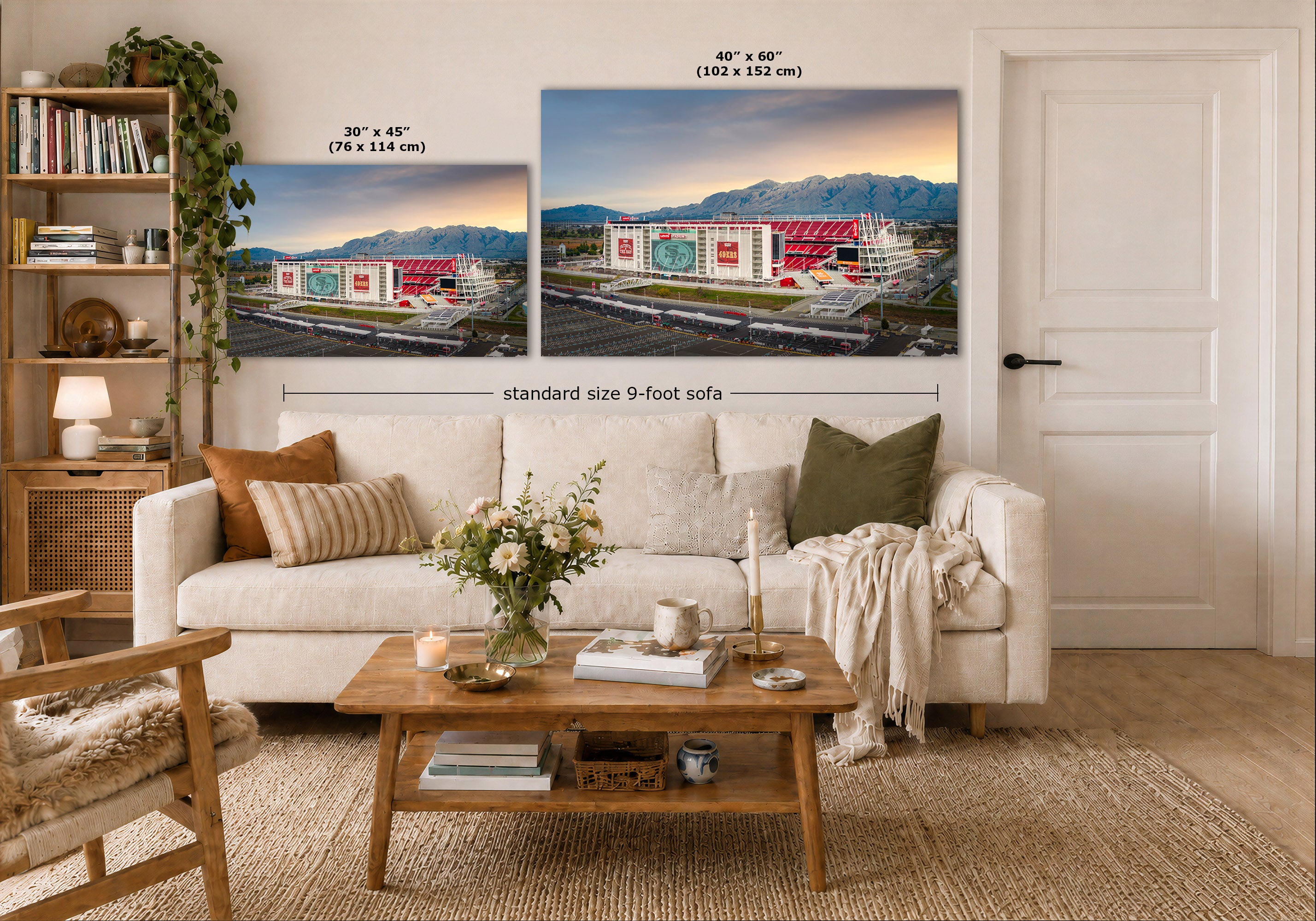 A styled living room showing two wall art prints above a white sofa. The prints depict a stadium scene at sunset, with one smaller 30 x 45 inch print and one larger 40 x 60 inch print.