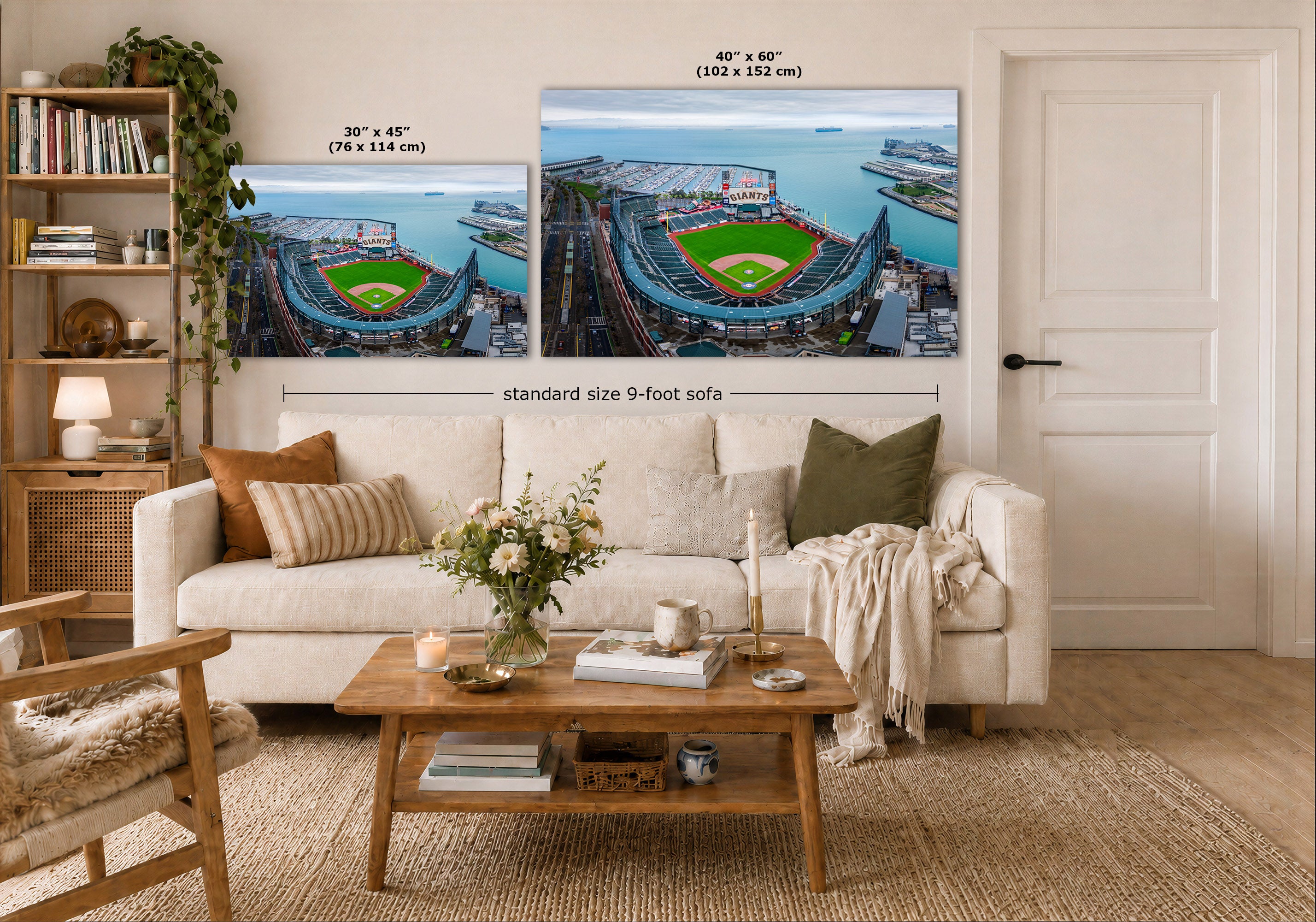 A styled living room showing two large wall art prints of the San Francisco Giants baseball stadium above a white sofa. The prints include size callouts: 30 x 45 inches (76 x 114 cm) and 40 x 60 inches (102 x 152 cm), with a note for a standard size 9-foot sofa.