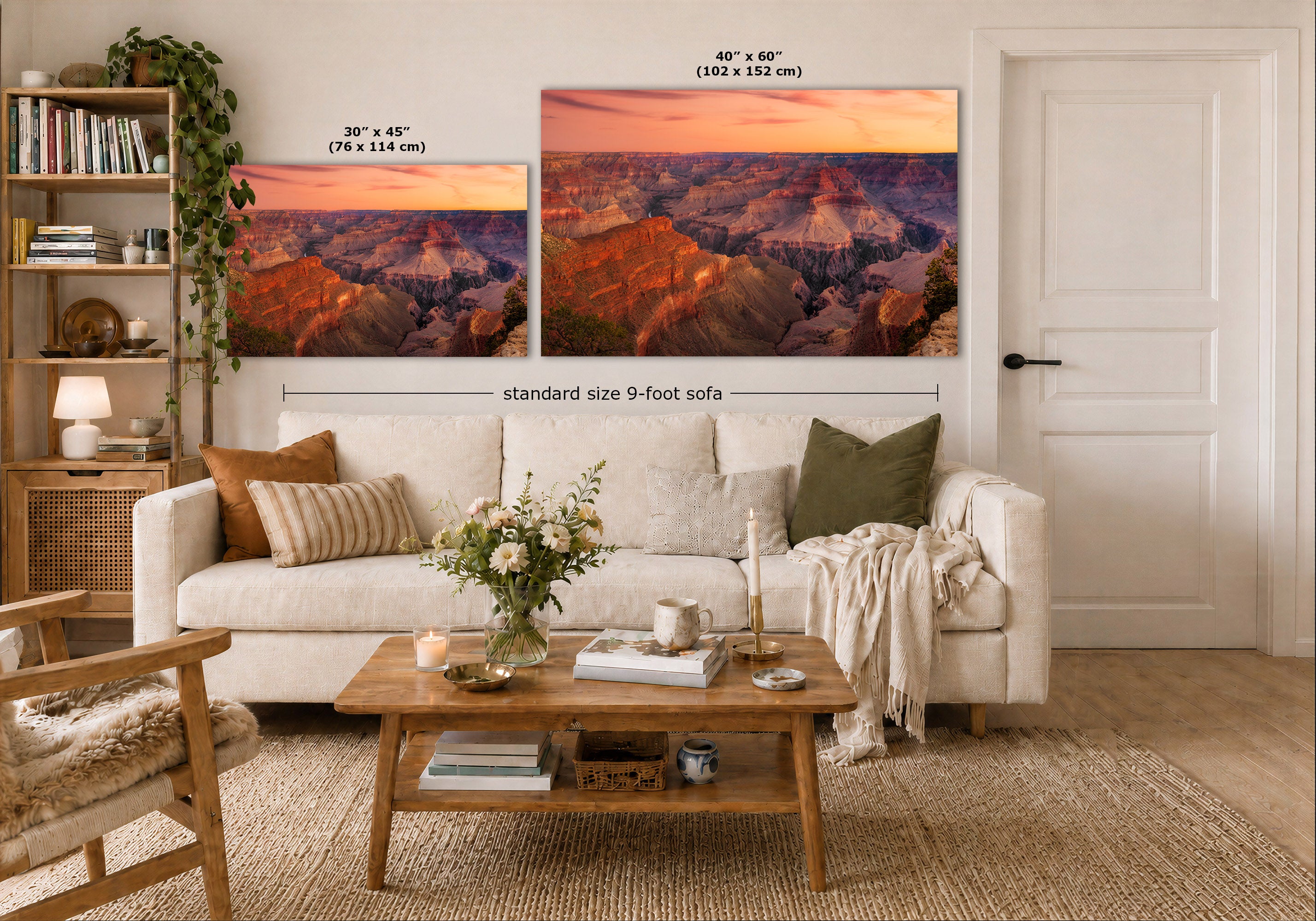A staged living room shows two wall art prints above a white sofa. The prints depict a canyon landscape at sunset in warm orange, pink, purple, and brown tones.