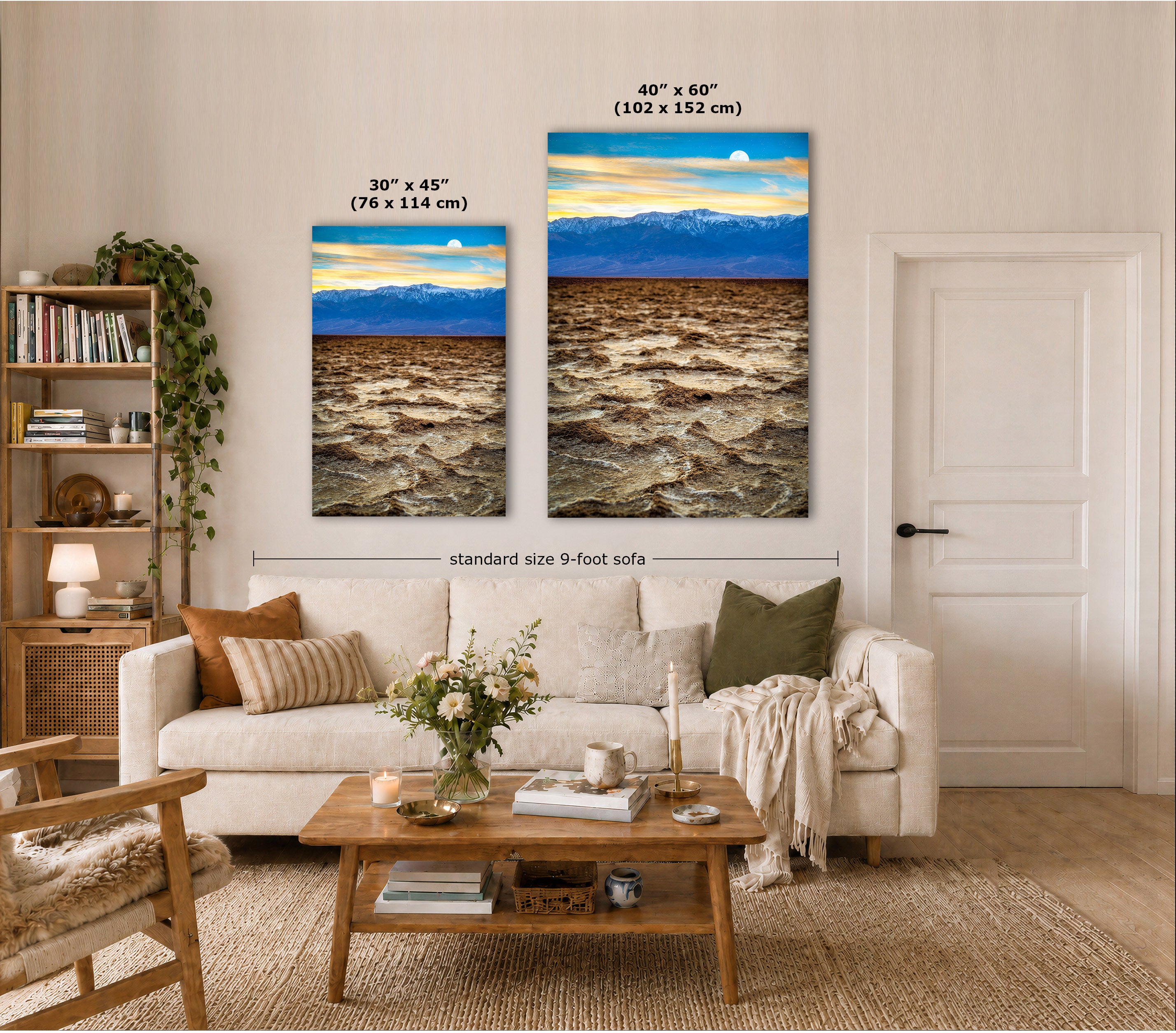 Two vertical canvas wall art prints showing a dramatic landscape with a bright blue sky, sun, and dark rushing water are displayed above a sofa in a styled living room. White text labels indicate the dimensions of each print: 30 x 45 inches and 40 x 60 inches, with a dimension line noting the standard size 9-foot sofa.