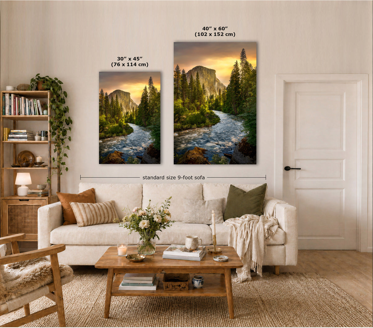 Two vertical canvas prints showing mountain river landscapes are displayed above a white sofa in a styled living room. White text overlays indicate the sizes of both prints: 30" x 45" on the left and 40" x 60" on the right, with a dimension line across the two prints reading 'standard size 9-foot sofa'.