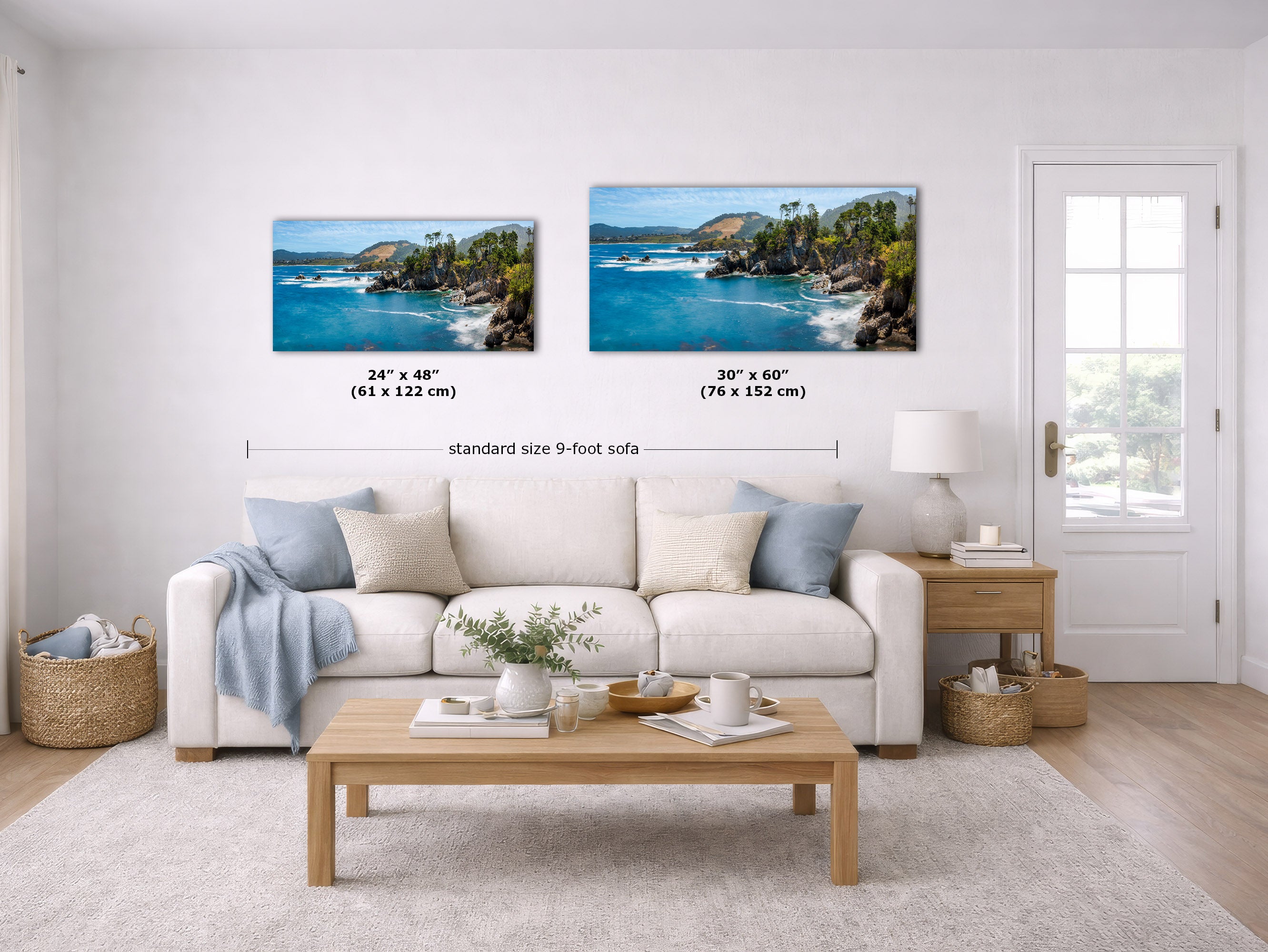 A staged living room shows two framed coastal landscape prints above a white sofa. The left print is labeled 24 x 48 inches and the right print 30 x 60 inches, with text reading 'standard size 9-foot sofa.