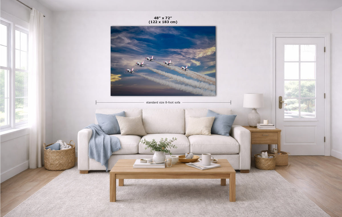 A large wall art print showing several airplanes flying through blue sky with white contrails, displayed above a white sofa in a bright modern living room. Measurement lines and text indicate the print size as 48 x 72 inches (122 x 183 cm).