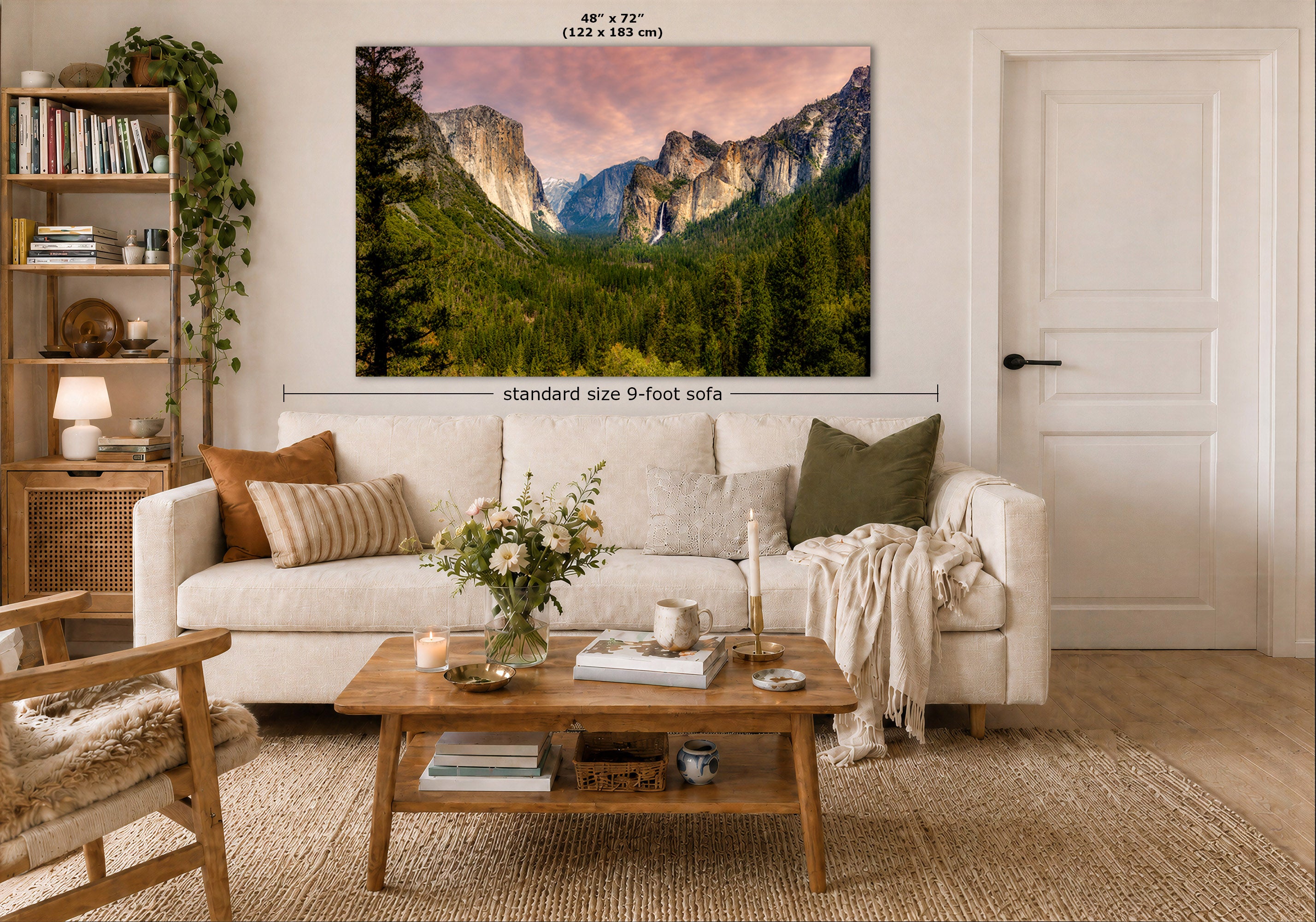 A large wall art print showing a mountain valley landscape hangs above a white sofa in a styled living room. The print includes size text reading 48" x 72" (122 x 183 cm) and a dimension label indicating standard size 9-foot sofa placement.