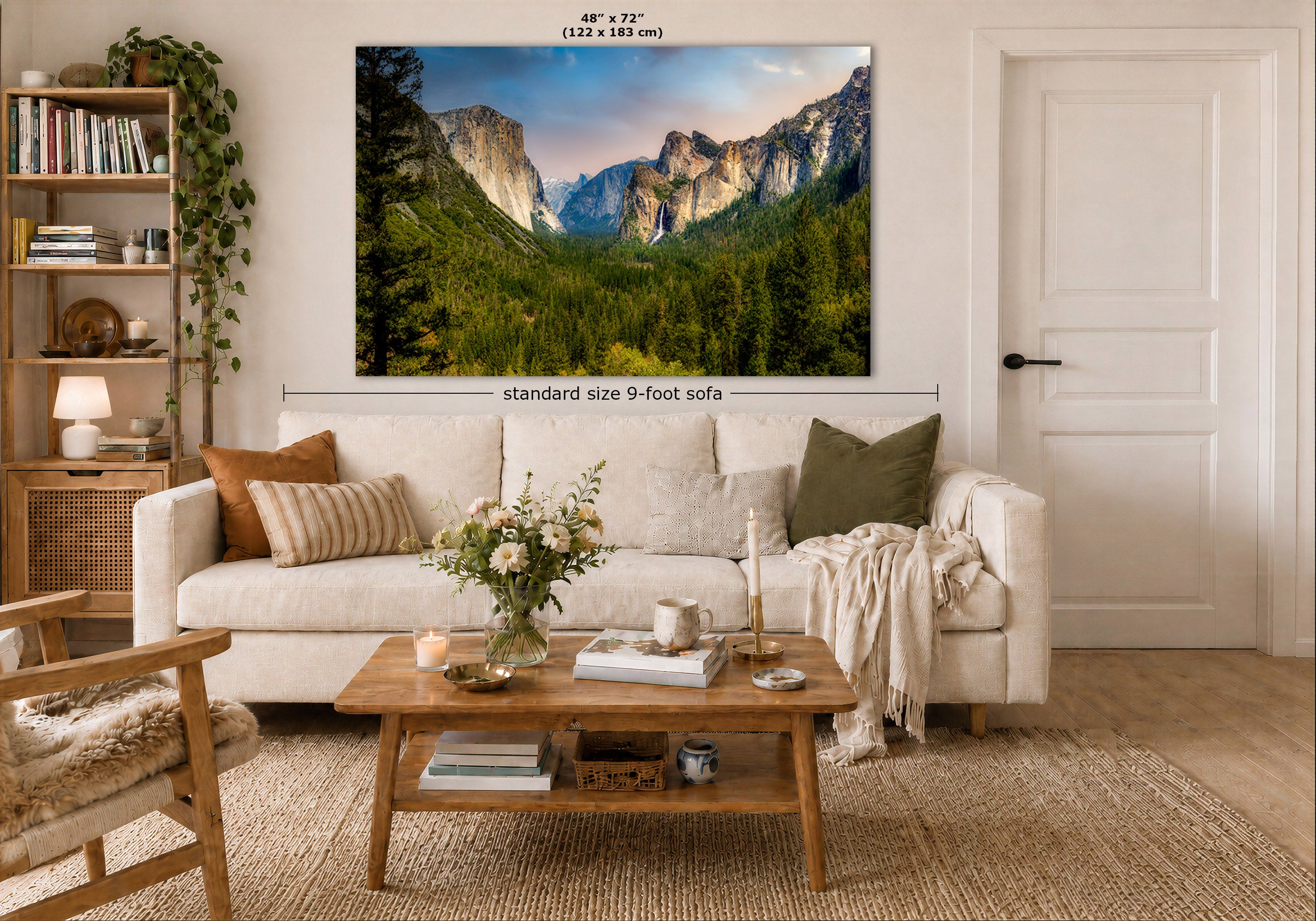 A large wall art print showing a mountain valley landscape is displayed above a white sofa in a styled living room. The print includes size markings reading 48 x 72 inches and a dimension label for a standard size 9-foot sofa.