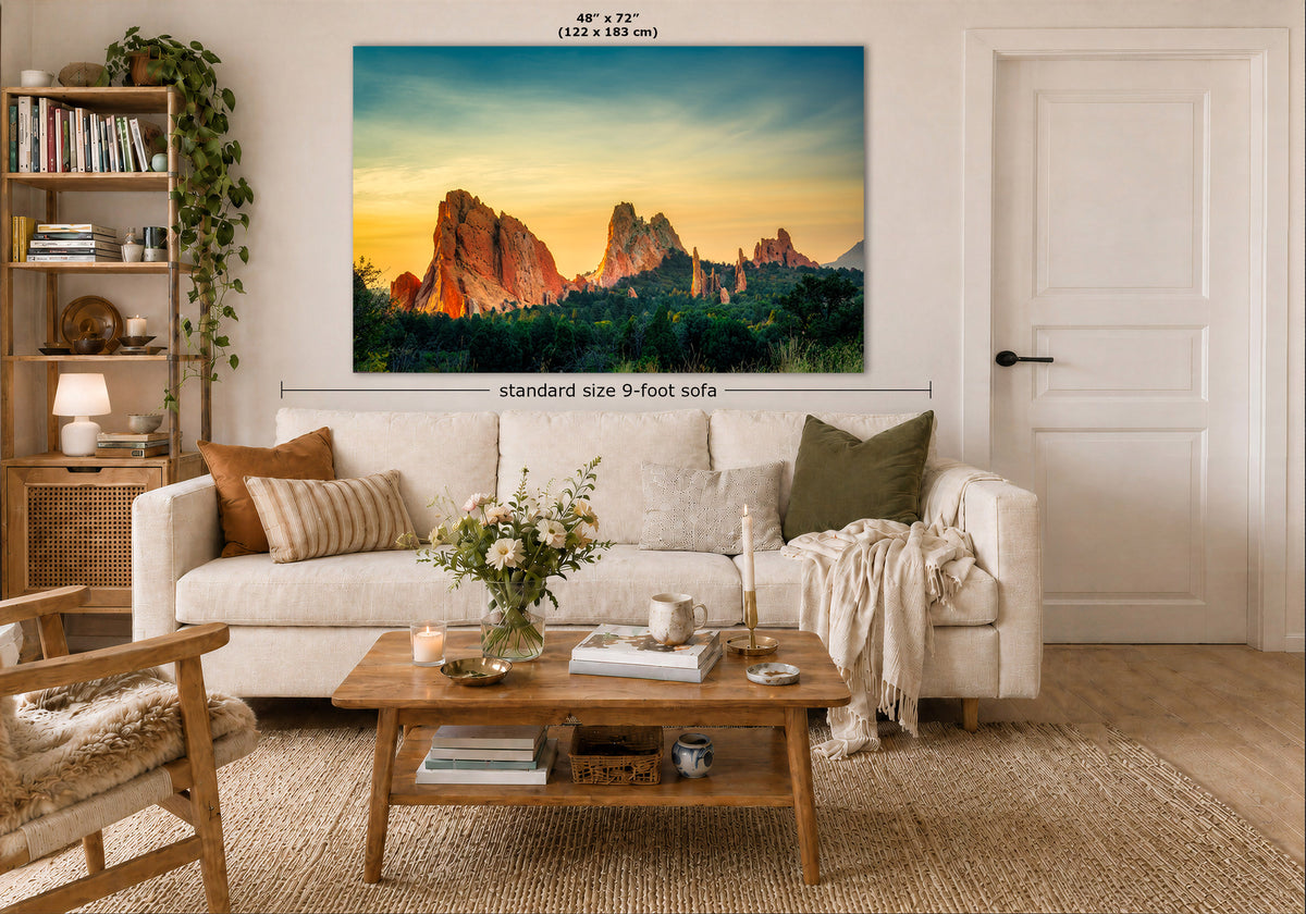 A large wall art print showing a desert rock landscape at sunset hangs above a white sofa in a styled living room. The image includes dimension labels indicating the print is 48 x 72 inches and the sofa is standard size 9-foot wide.