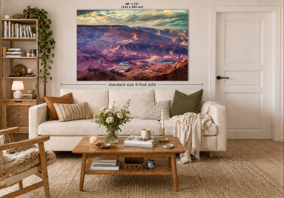A large rectangular wall art print showing a colorful canyon landscape is displayed above a white sofa in a styled living room. White text above the print reads 48" x 72" (122 x 183 cm), and a dimension line indicates standard size 9-foot sofa.
