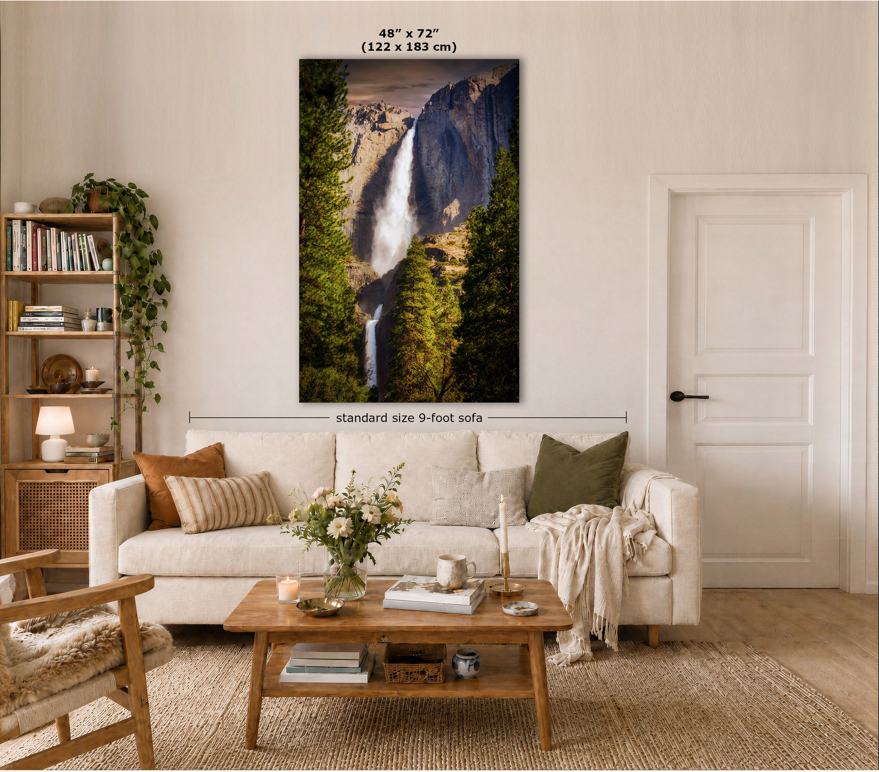 A large vertical wall art print showing a waterfall in a forest canyon, displayed above a white sofa in a styled living room. Text at the top reads 48" x 72" (122 x 183 cm), and a dimension line notes standard size 9-foot sofa.